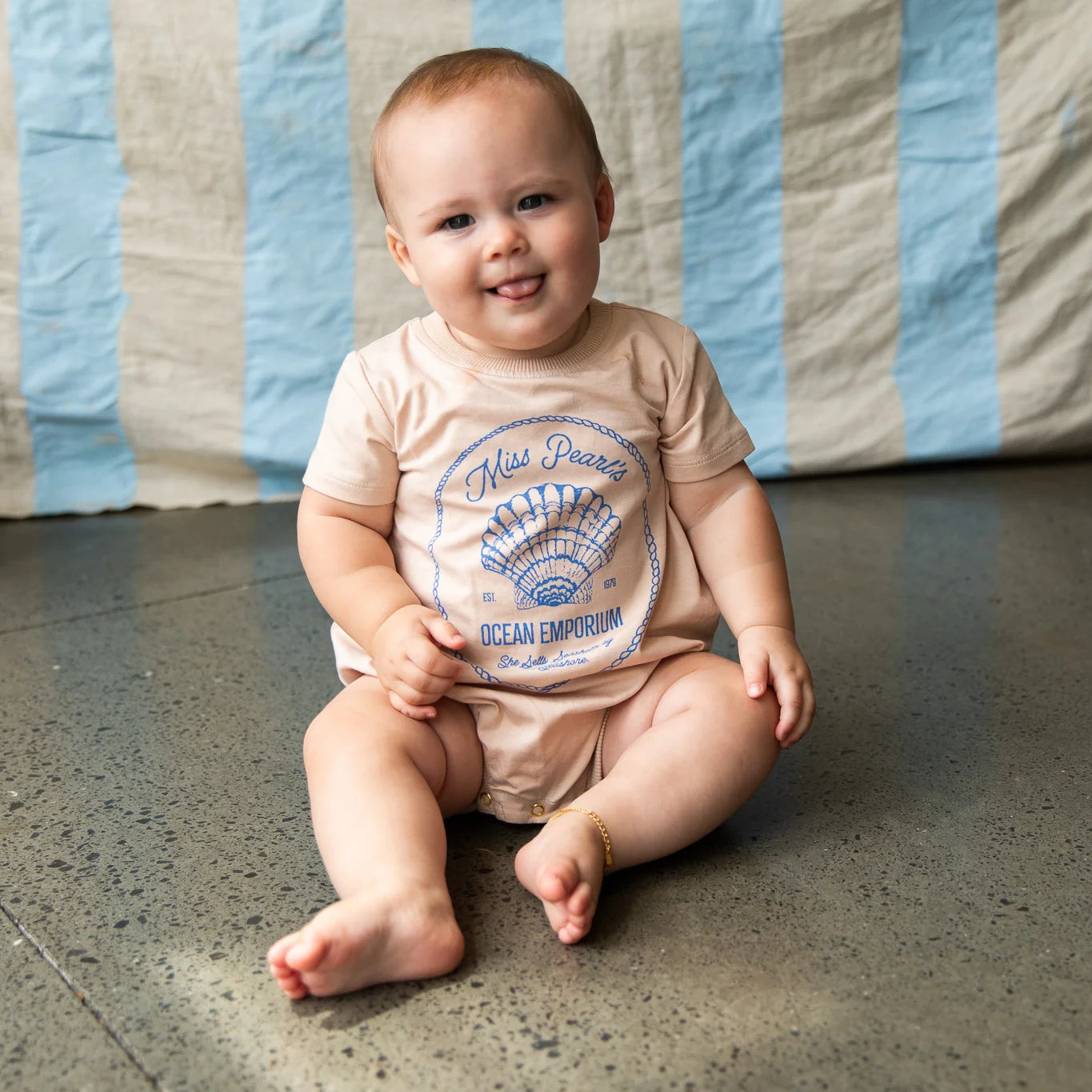 Baby wearing the Indi Romper - Sand by Pearson & Pearson