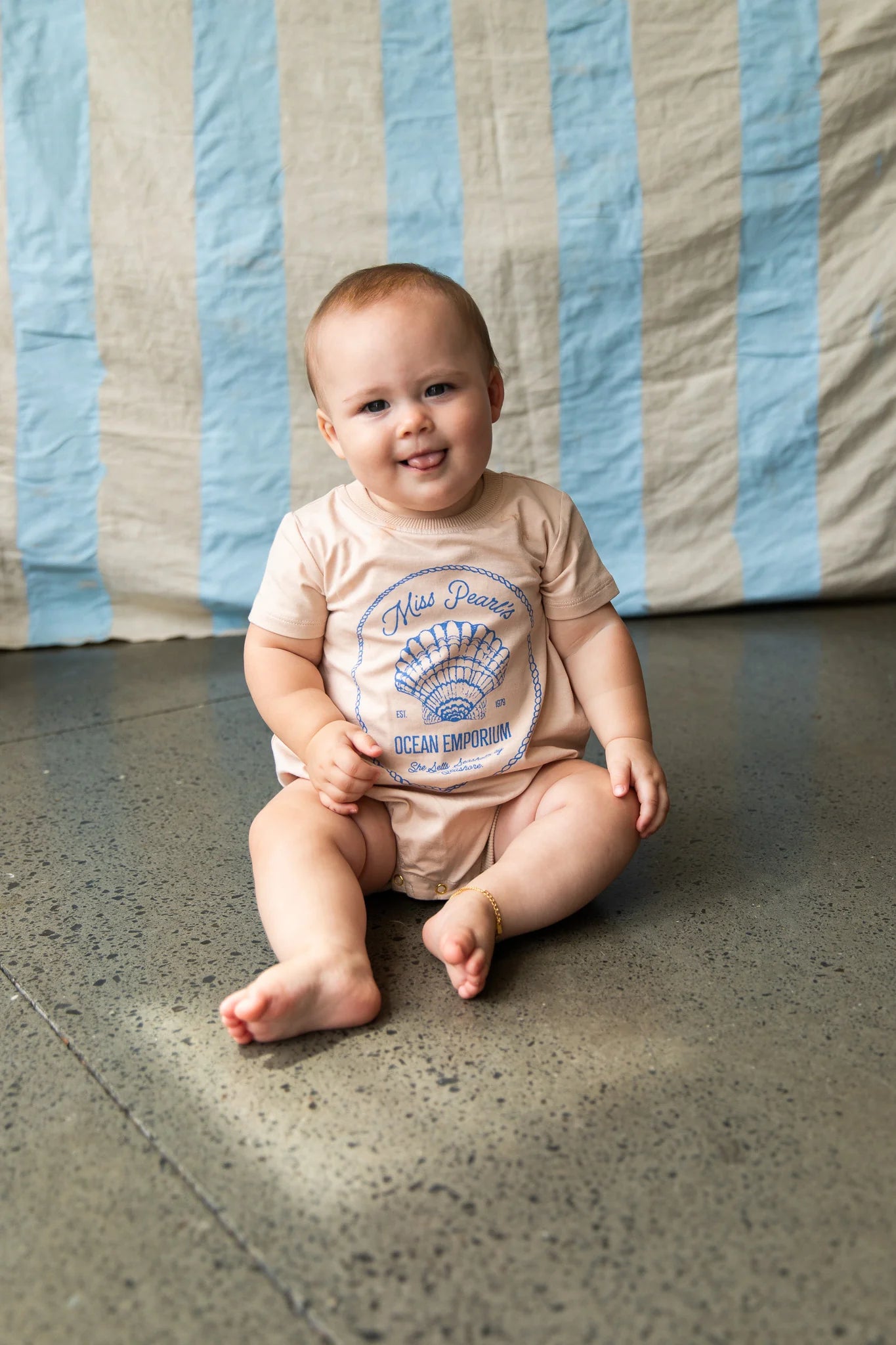 Baby wearing the Indi Romper - Sand by Pearson & Pearson