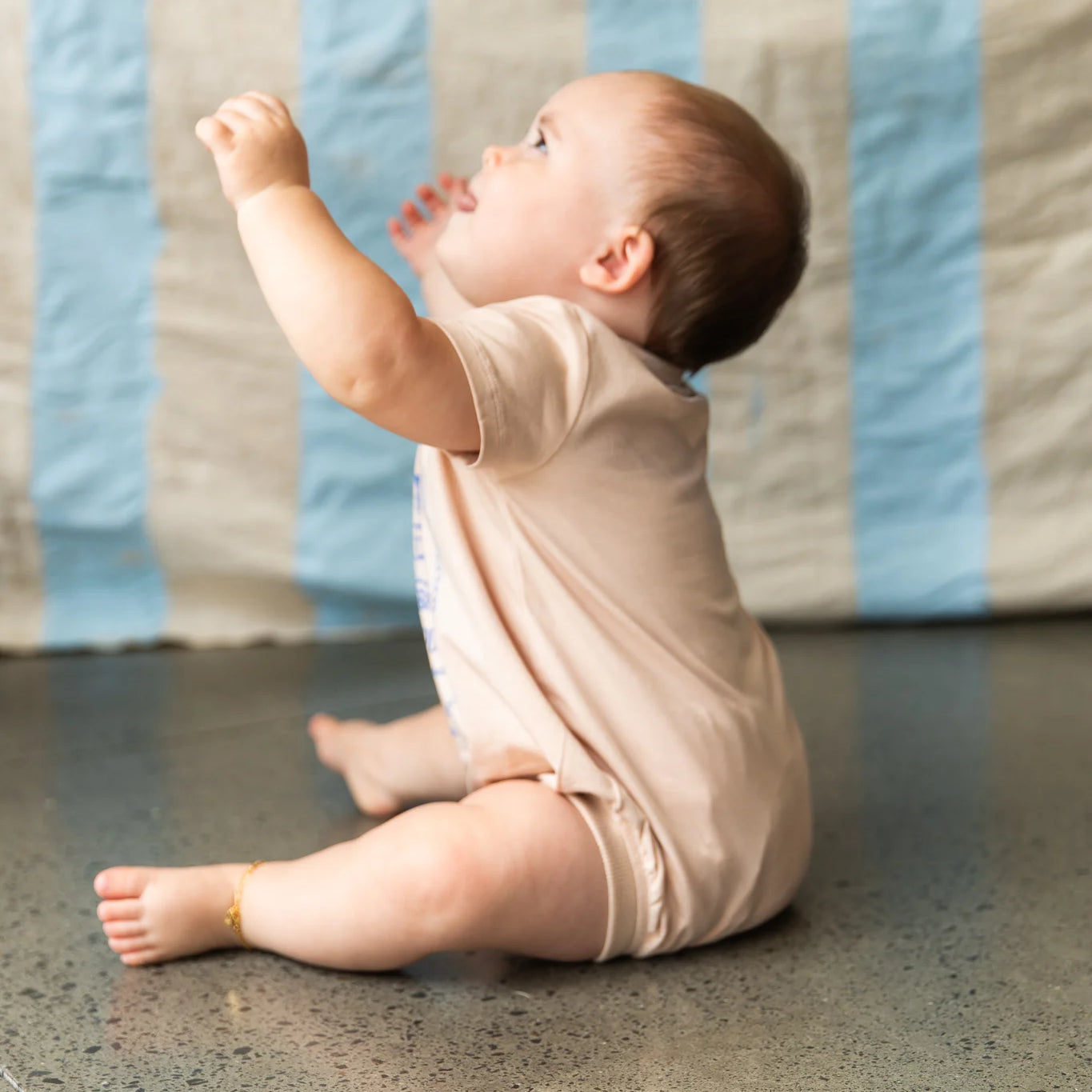 baby wearing cream coloured onesie by Pearson and Pearson ( Formerly Bella & Lace )