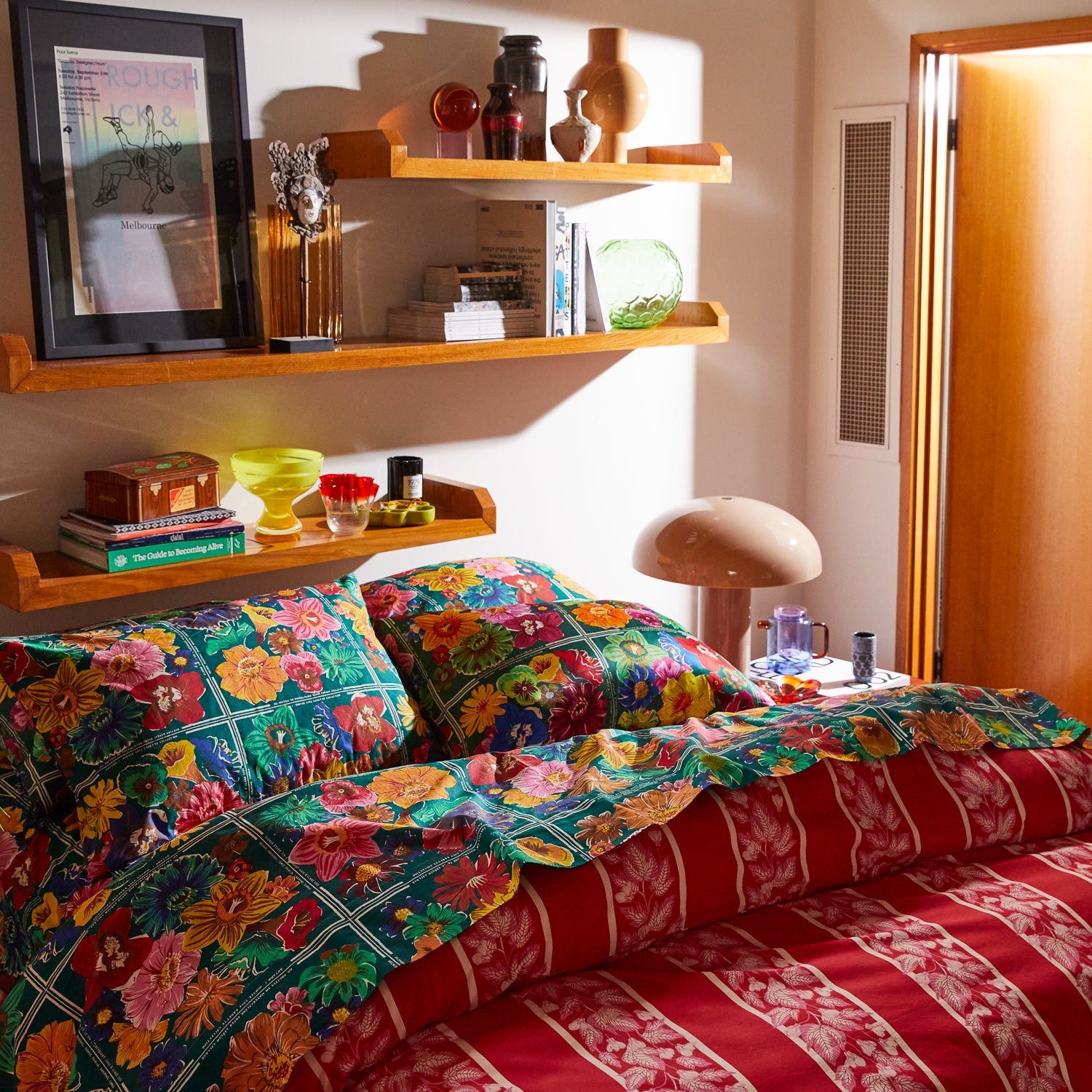 Luxury bedroom setting featuring Ines Silk Pillowcase Verdant with floating shelves and modern decor