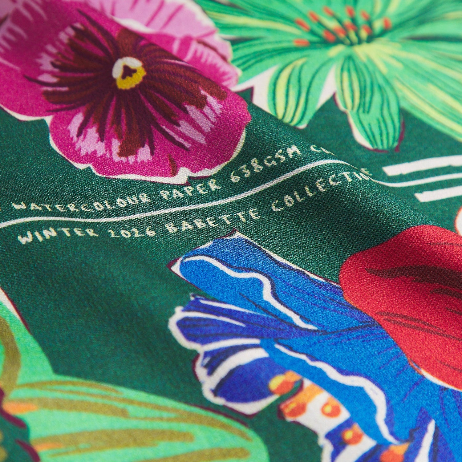 Extreme close-up of floral pattern and silk fabric texture on Ines Silk Pillowcase Verdant by Sage & Clare