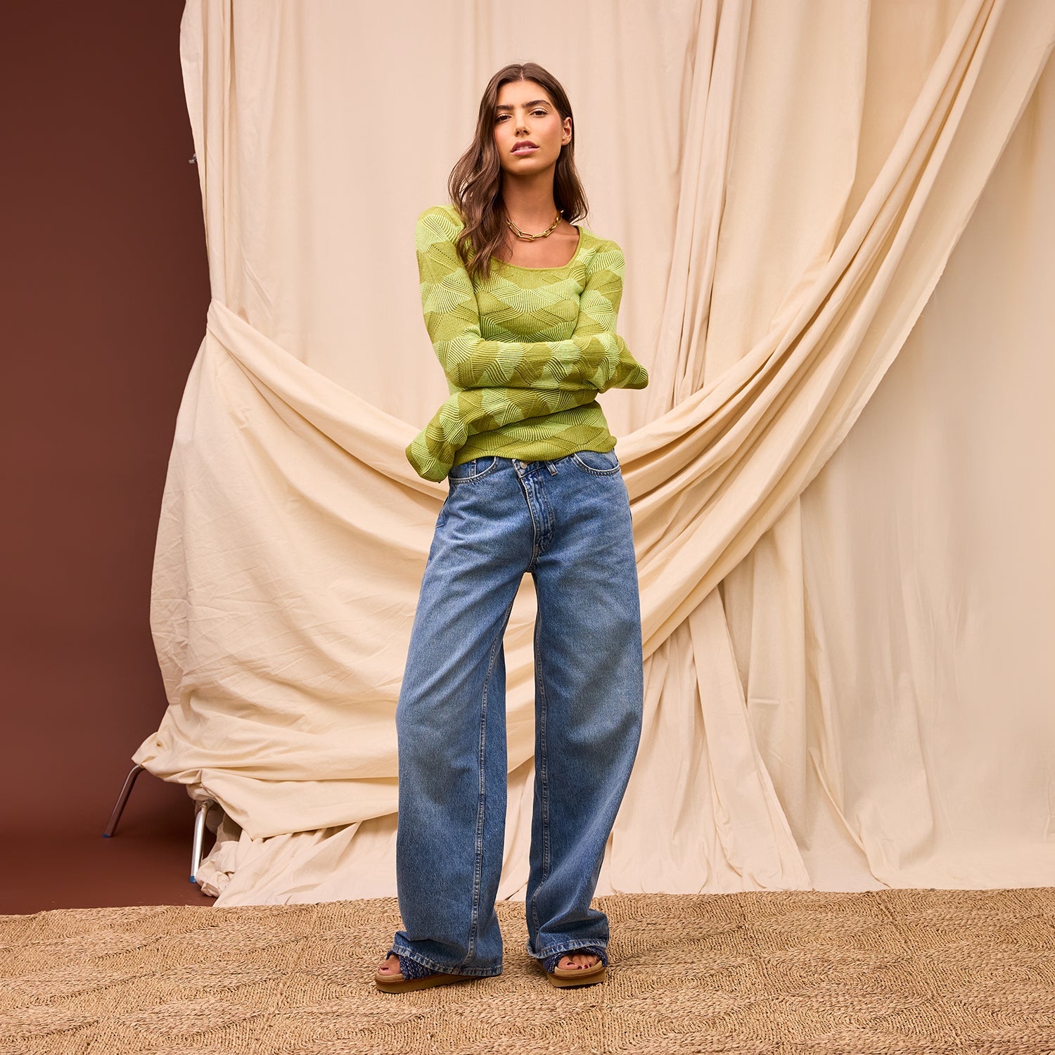 Flared sleeve construction detail on juniper merino wool knit top