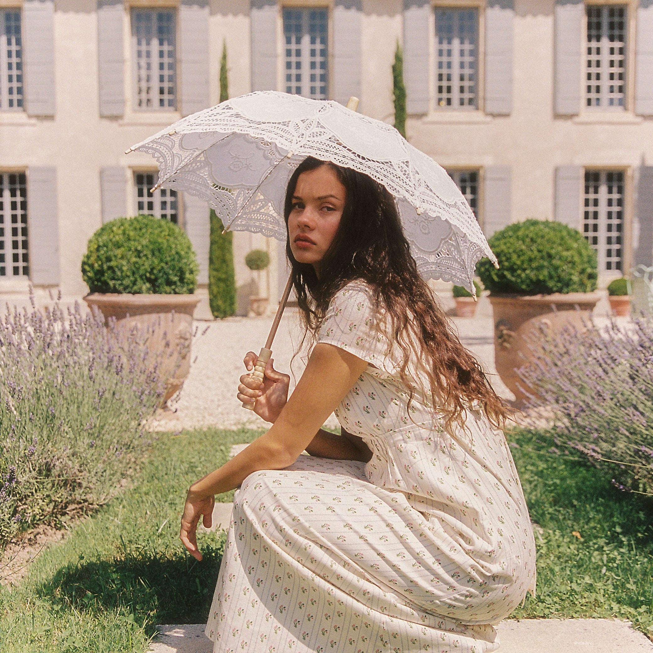 lady holding a sun umbrella while wearing the Irina Maxi Dress Poppy Stripe by Juni
