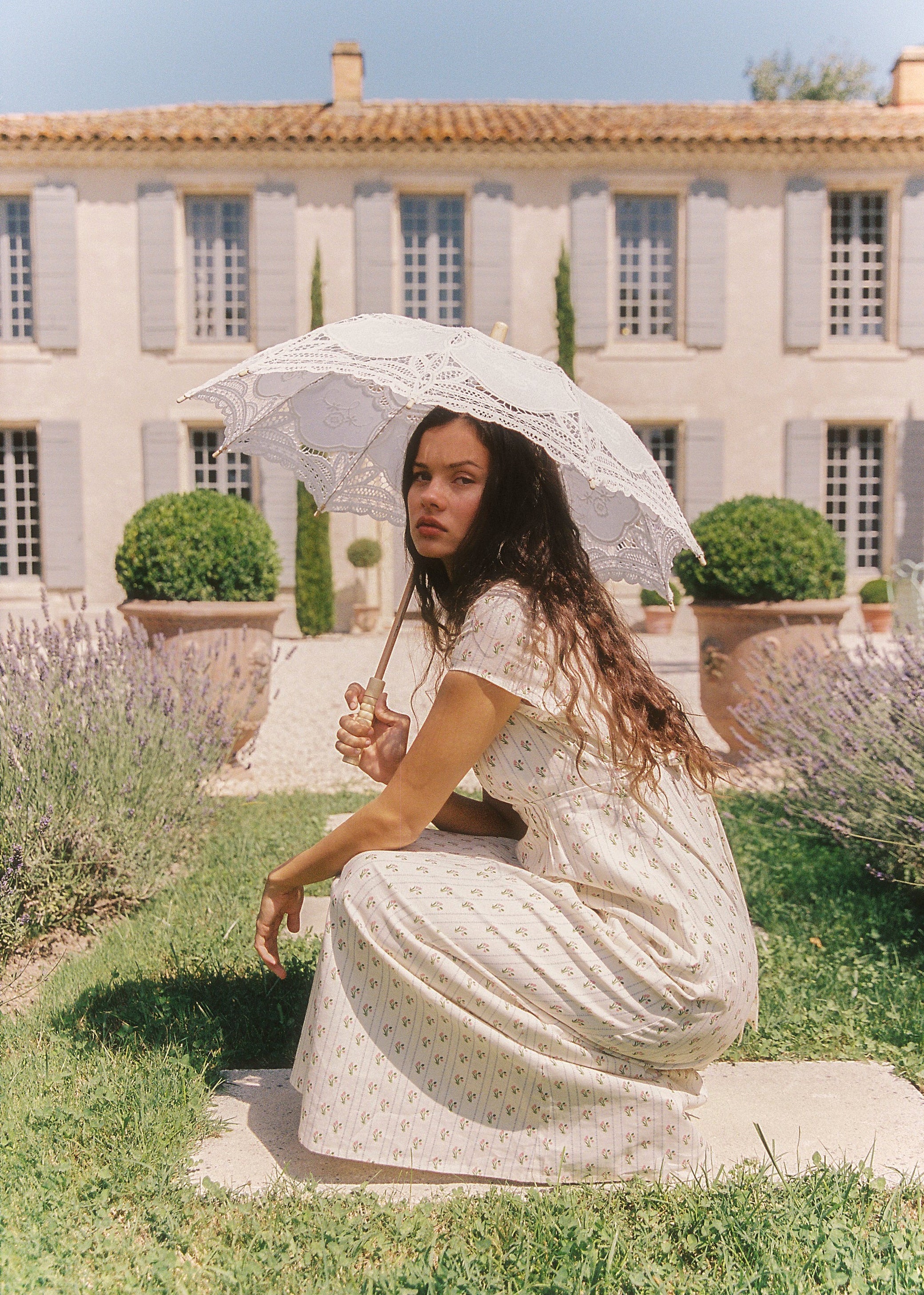 lady holding a sun umbrella while wearing the Irina Maxi Dress Poppy Stripe by Juni