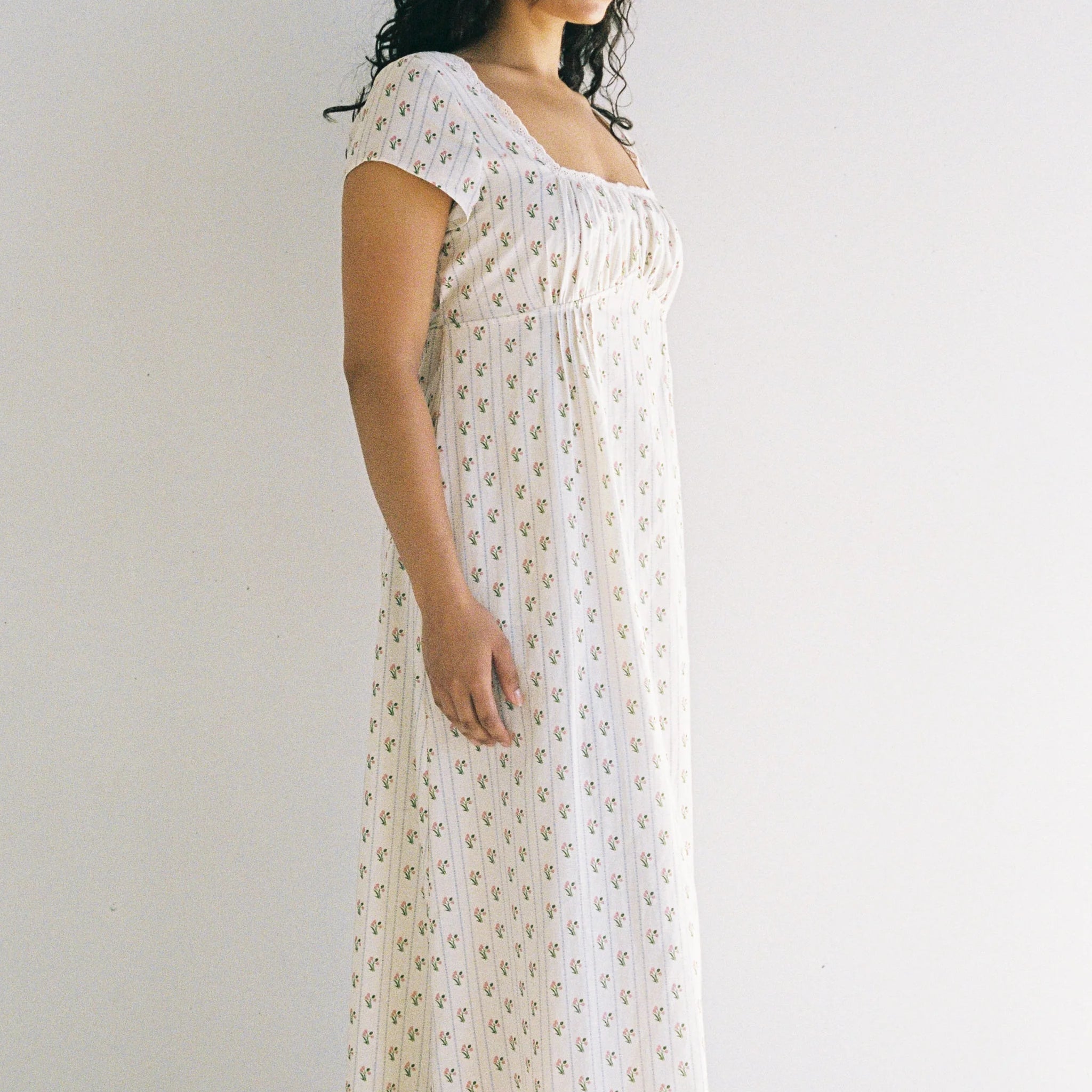 side profile of lady wearing Irina Maxi Dress Poppy Stripe by Juni