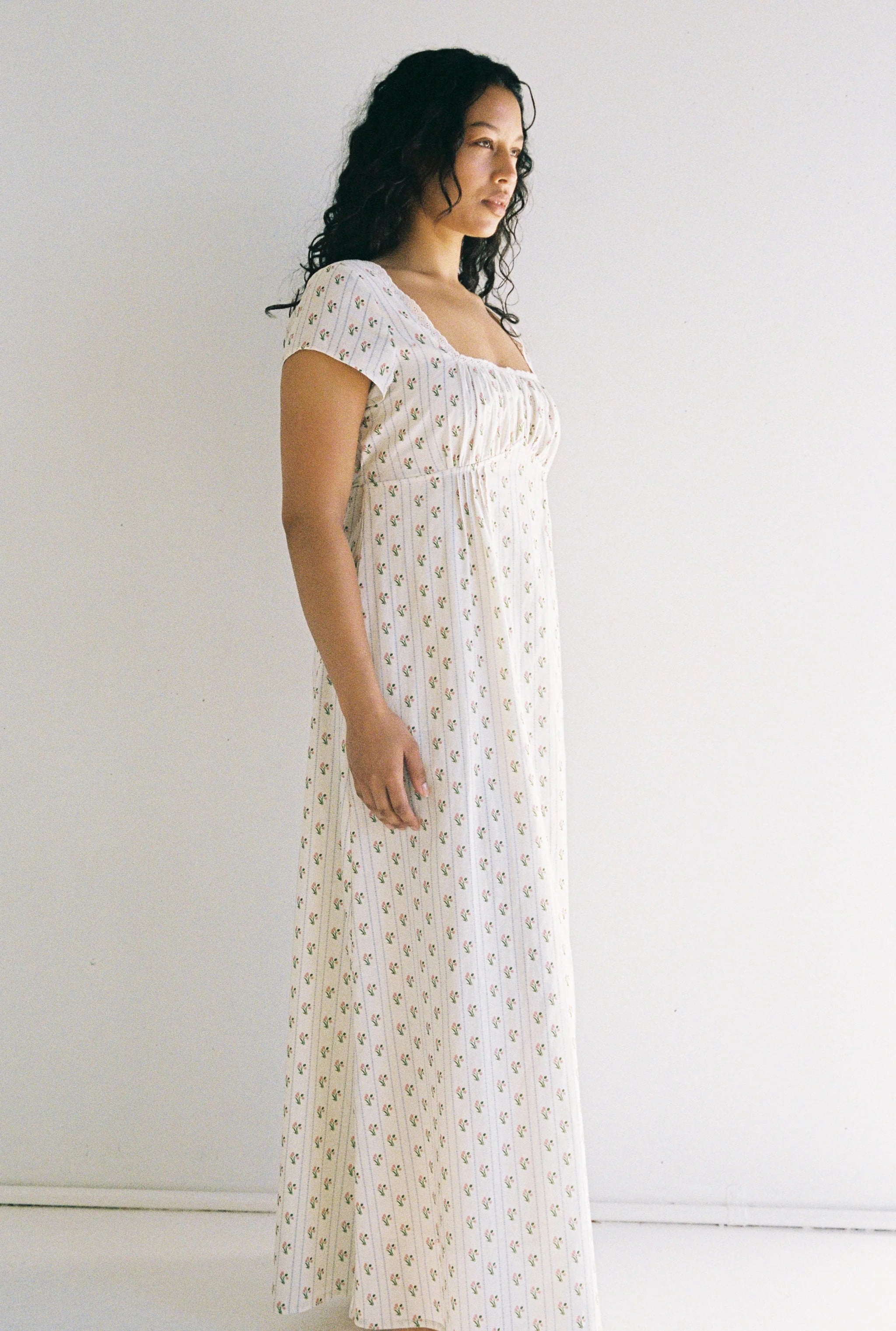 side profile of lady wearing Irina Maxi Dress Poppy Stripe by Juni