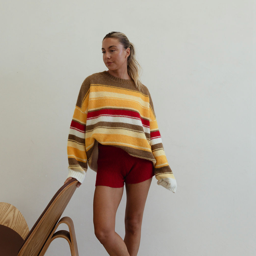 Standing view of Isabel Knit autumn stripe sweater showing full length and relaxed oversized silhouette