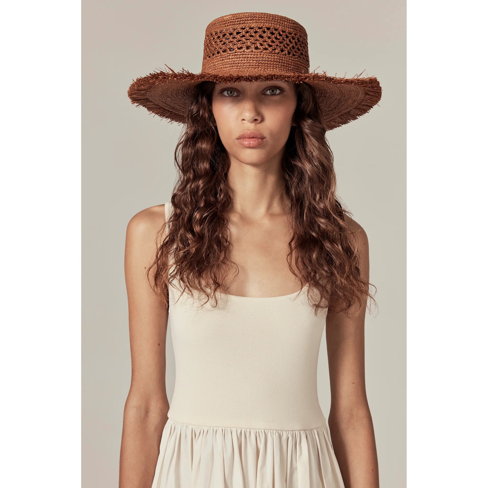 Model wearing Ivy Raffia Boater by Helen Kaminski