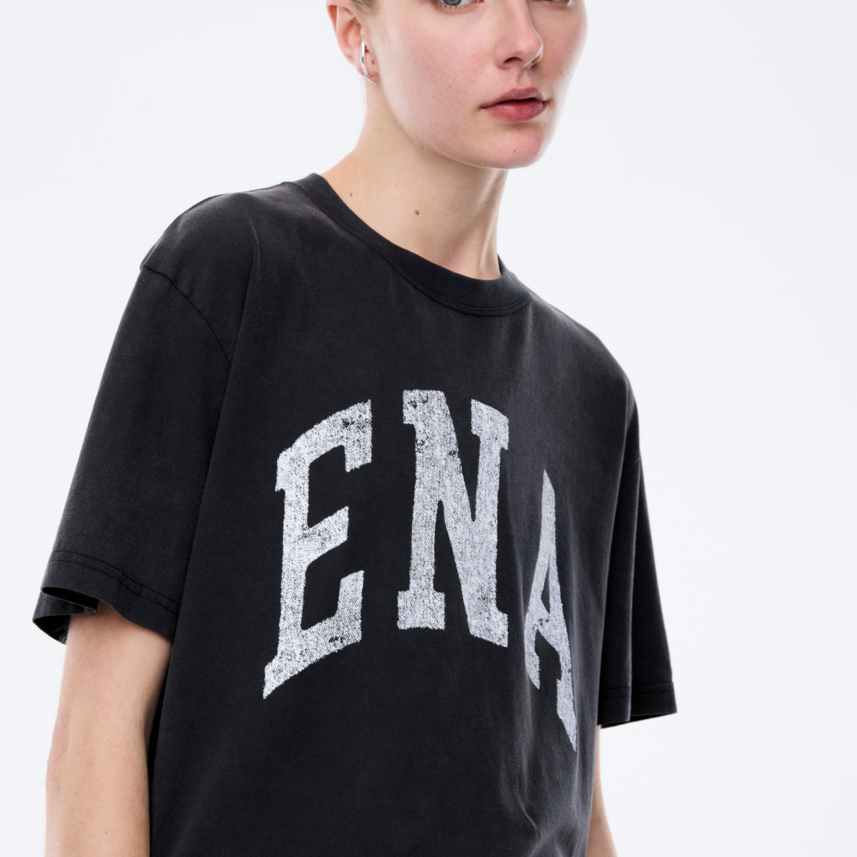 Close-up front view of Jessie oversized tee in charcoal with white collegiate ENA graphic print