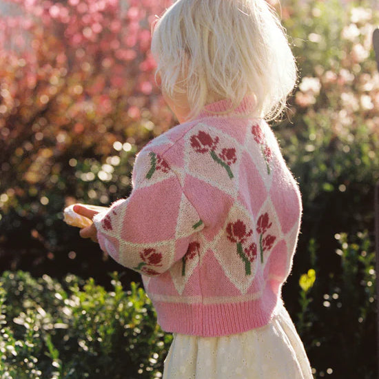 girl wearing pink floral cardigan by JUNI