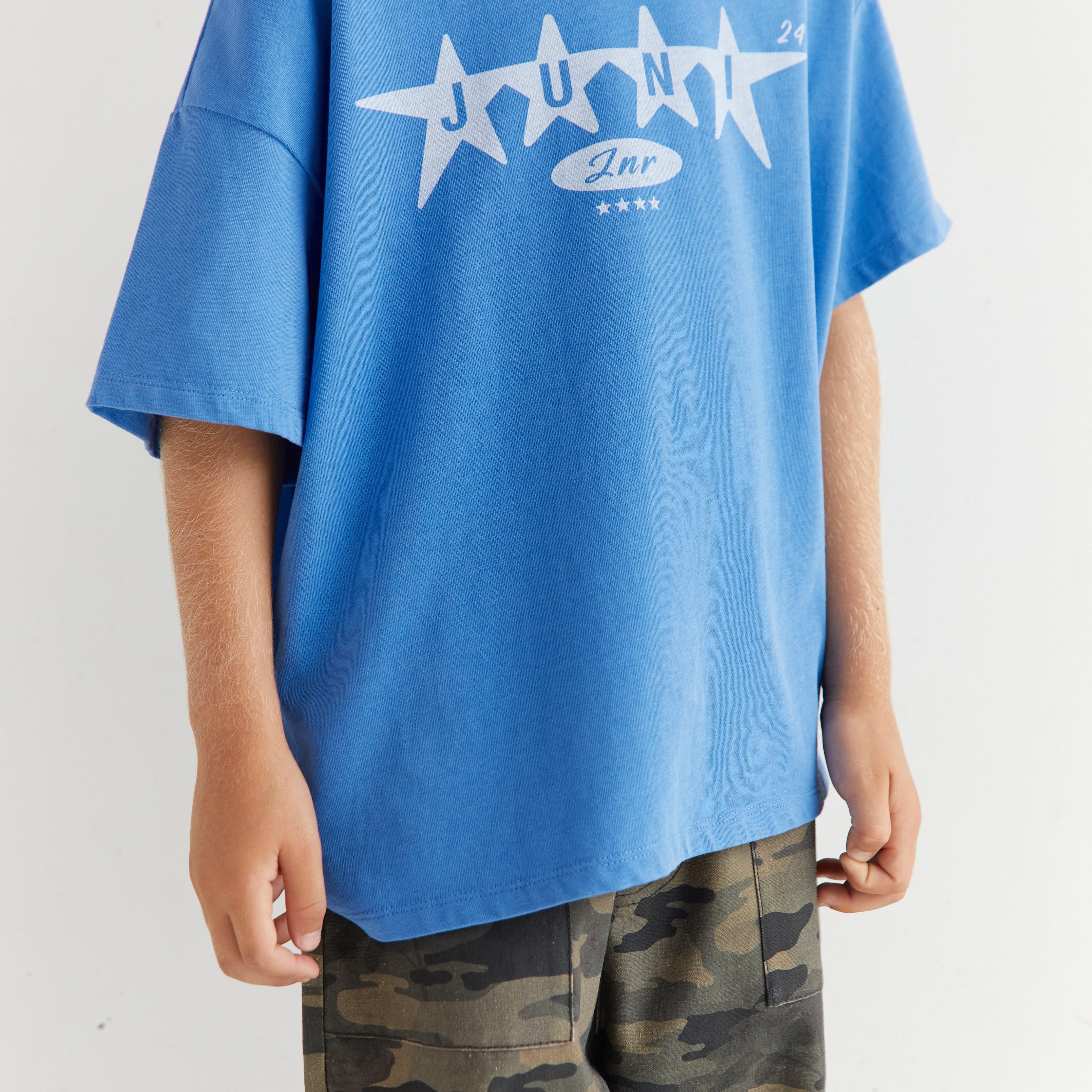 Front view close-up of azure blue Star Tee showing white star graphic and relaxed fit
