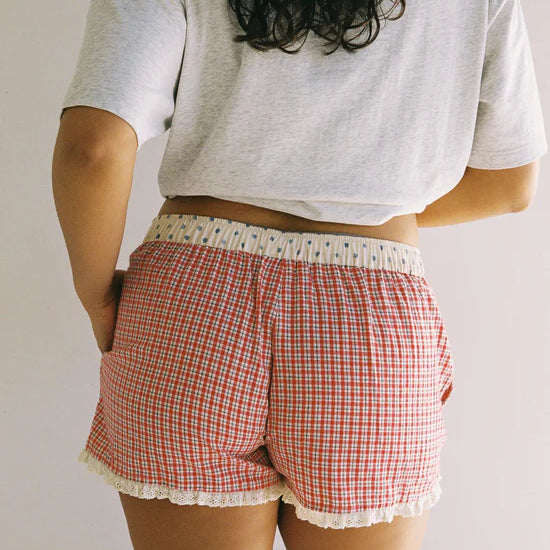 Juni shorts with red check pattern