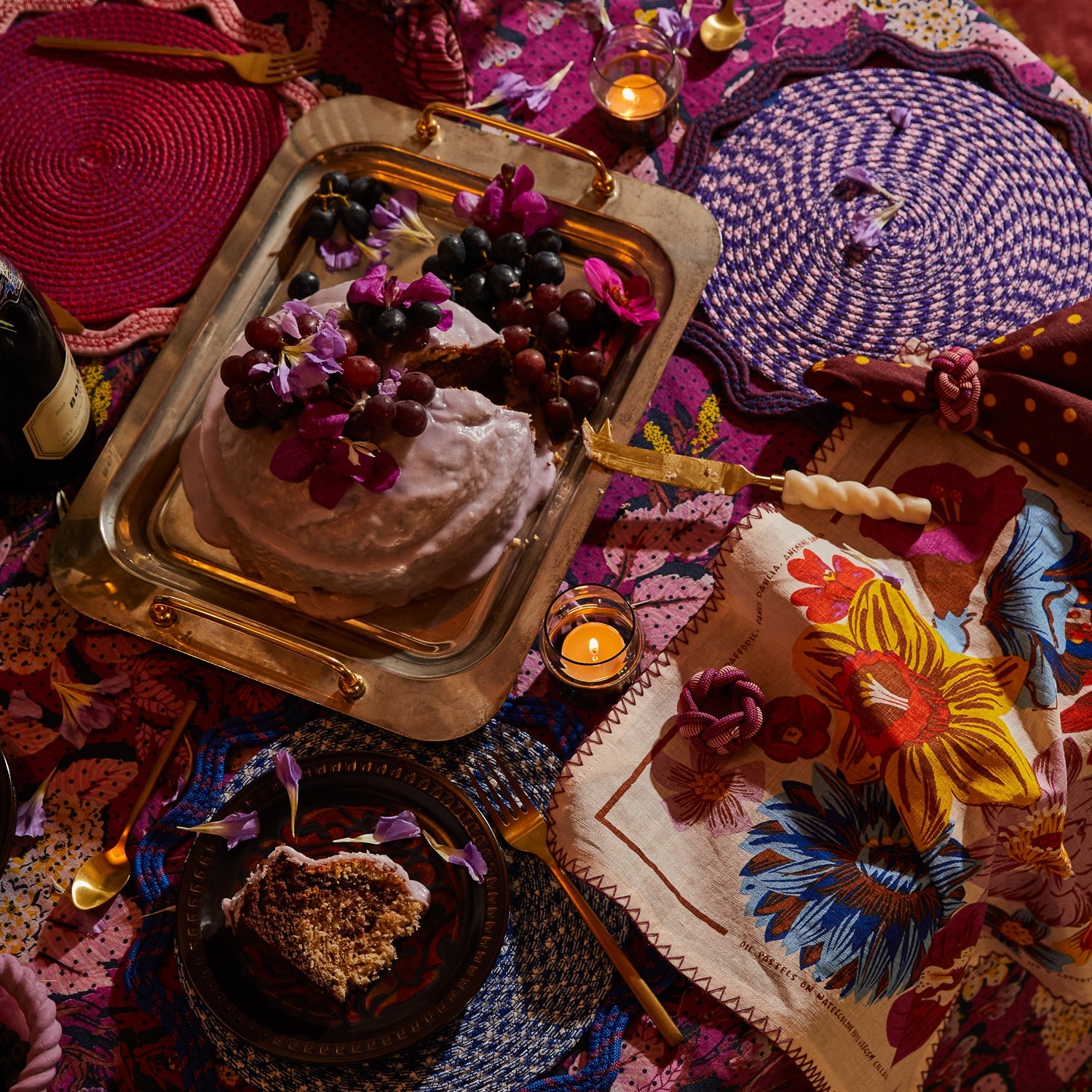 Pearl handle Julia cheese knife resting beside a frosted cake on a styled bohemian tablescape