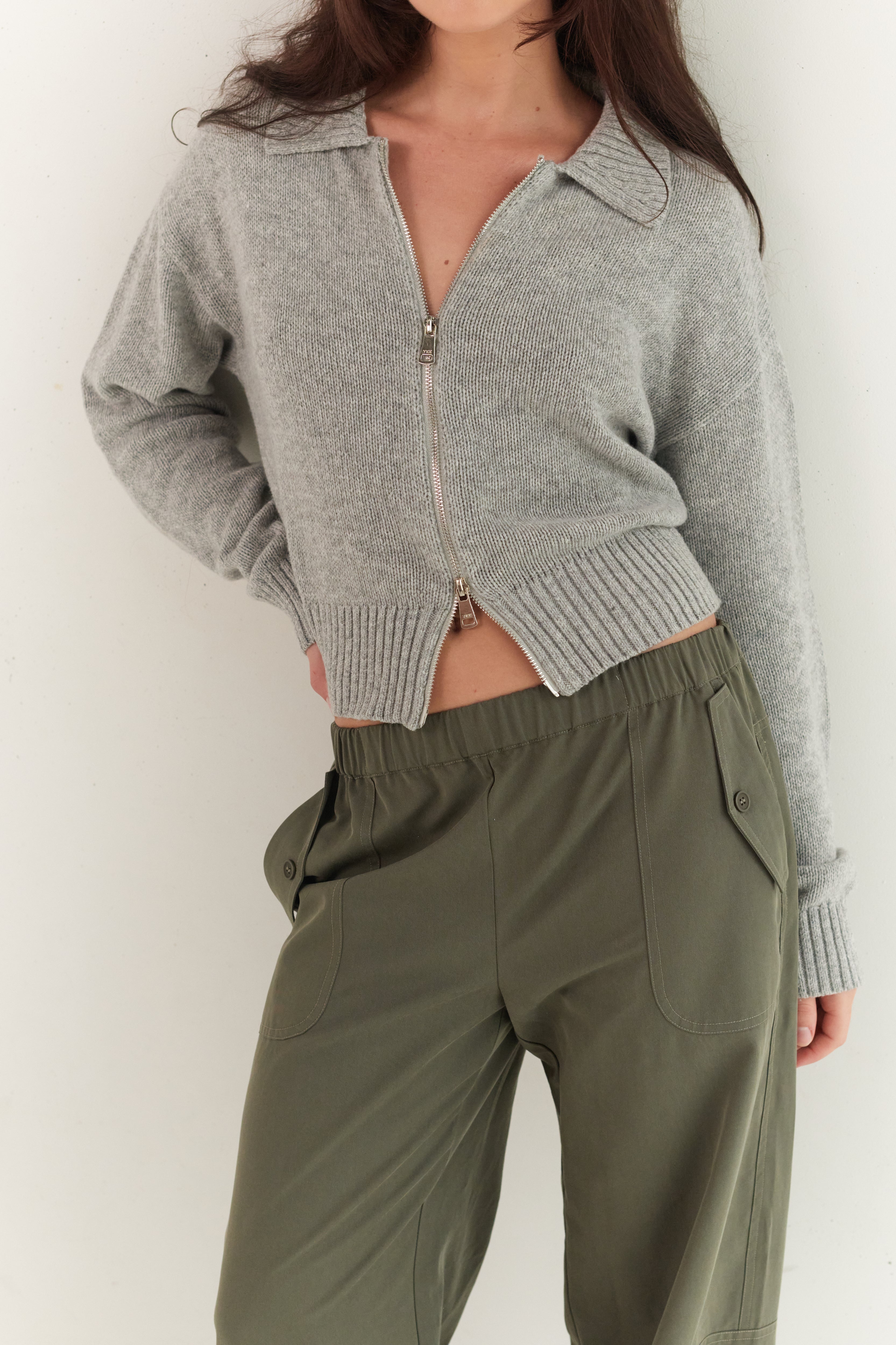 Close-up front view of stone grey Kaia Zip Cardigan showing knit texture and zip detail