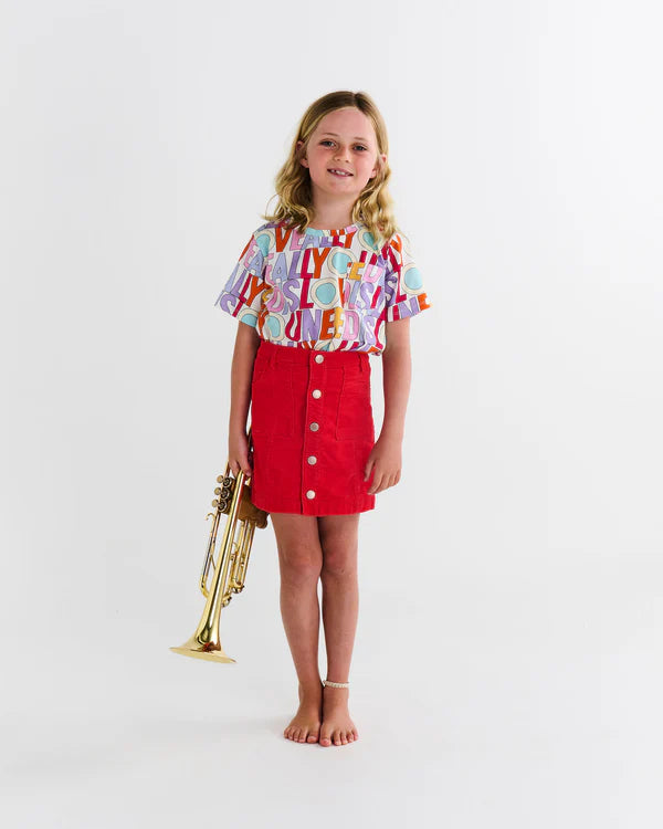 girl wearing Kip & Co x The Beatles All You Need Is Love Organic Cotton Kids T-Shirt