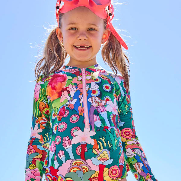 girl wearing Kip & Co x The Beatles Big Flower Dreamscape Long Sleeve Bathers