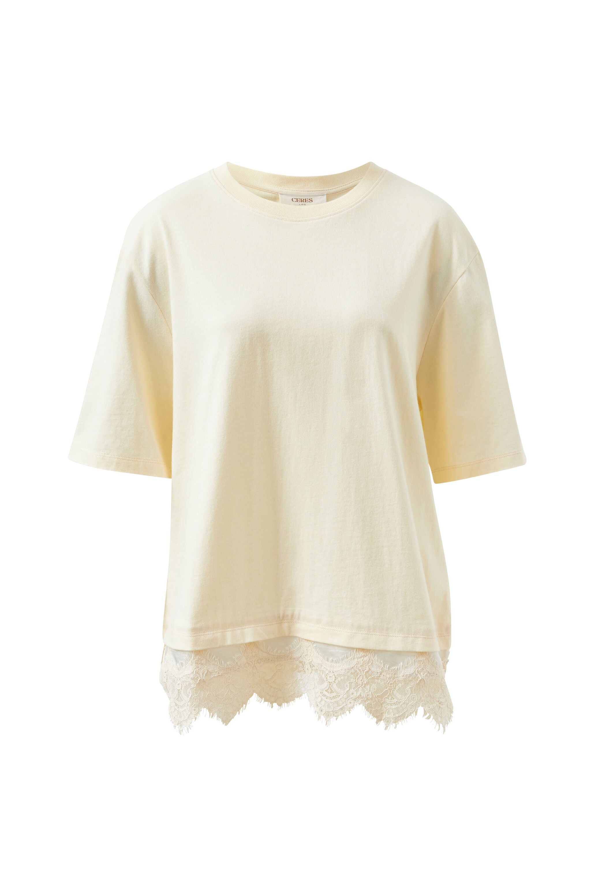 Flat lay of Lacey Tee showing marshmallow cream color with white lace trim hemline