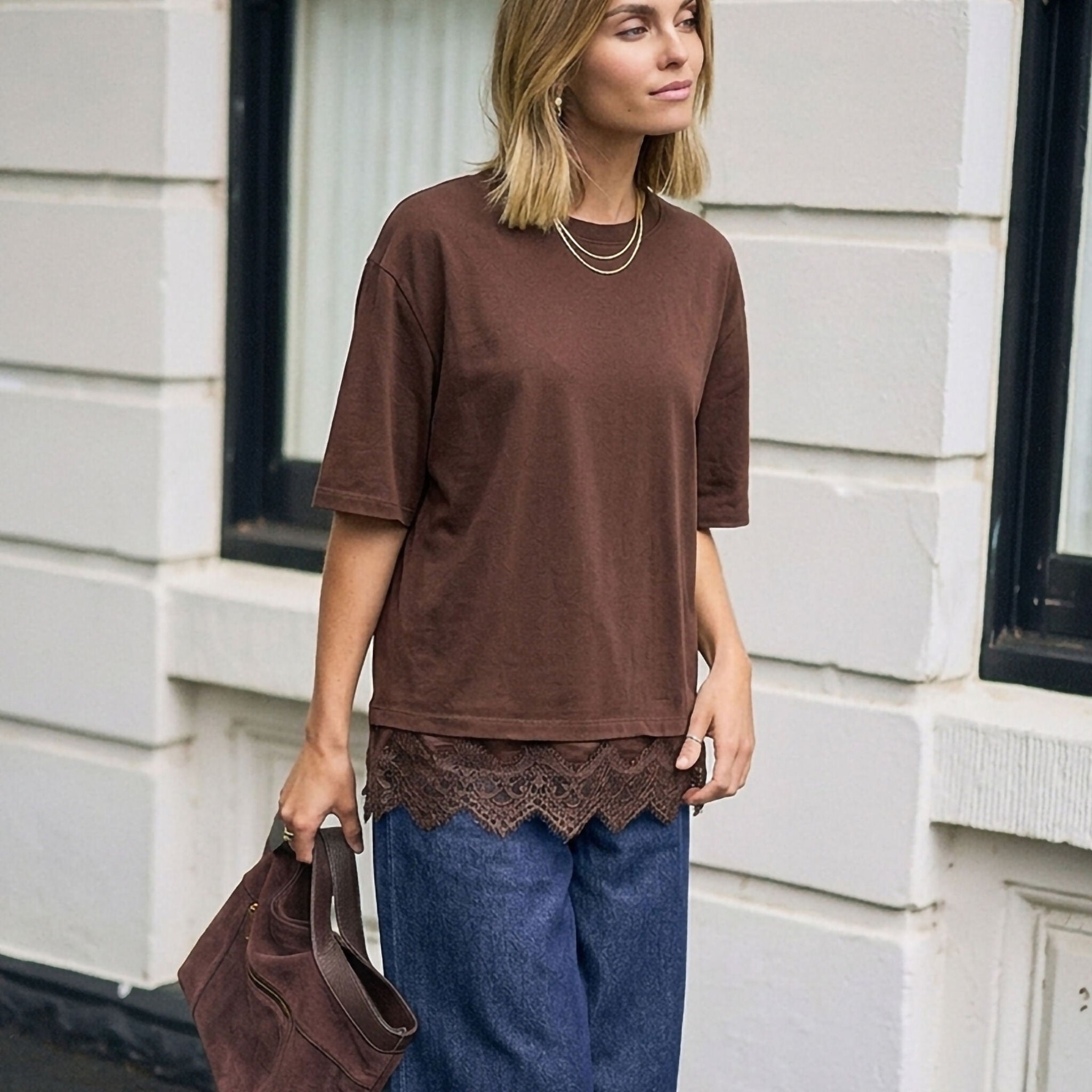Side profile of model wearing chocolate brown Lacey Tee with decorative lace edging