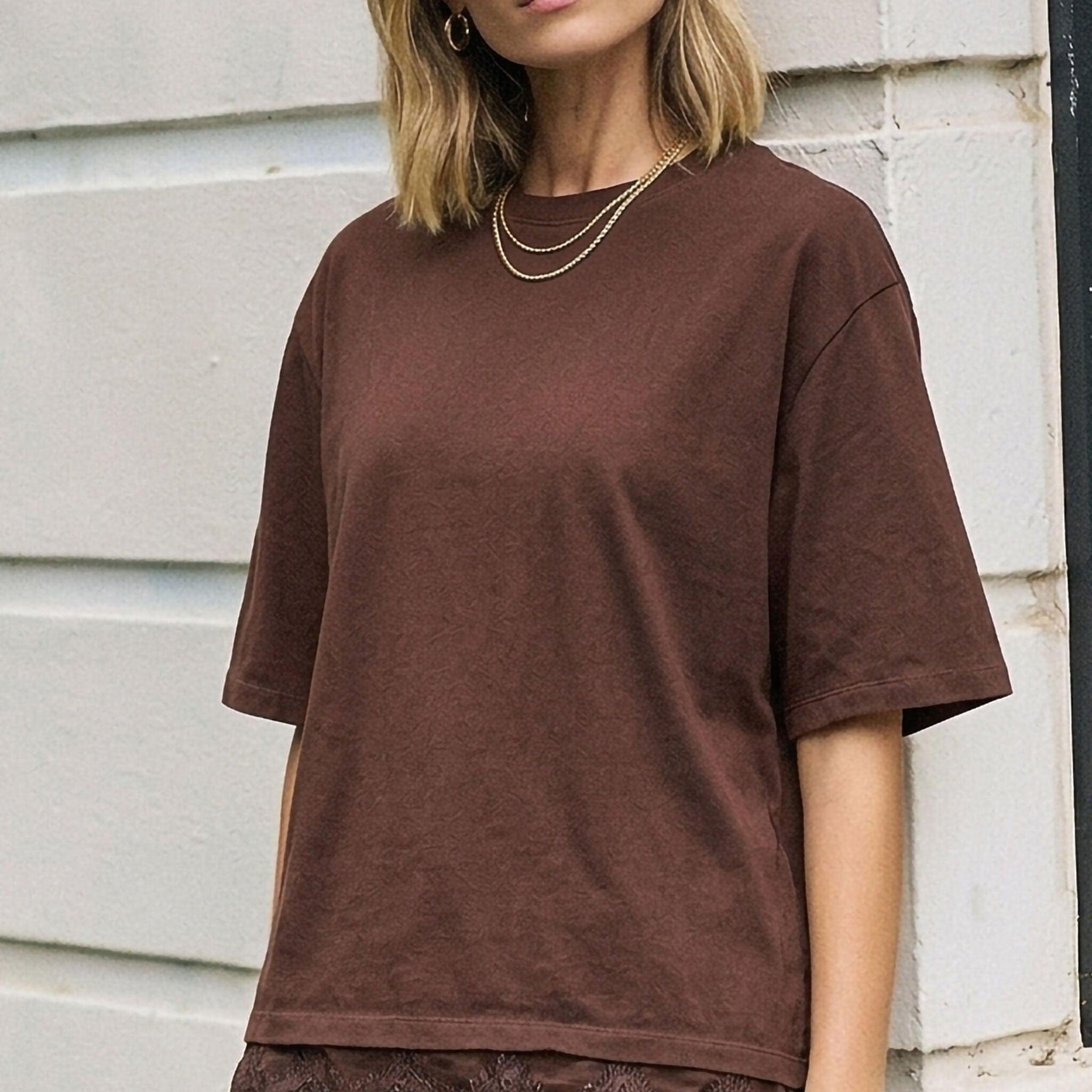 Close-up front view of chocolate brown Lacey Tee highlighting lace detail at bottom hem