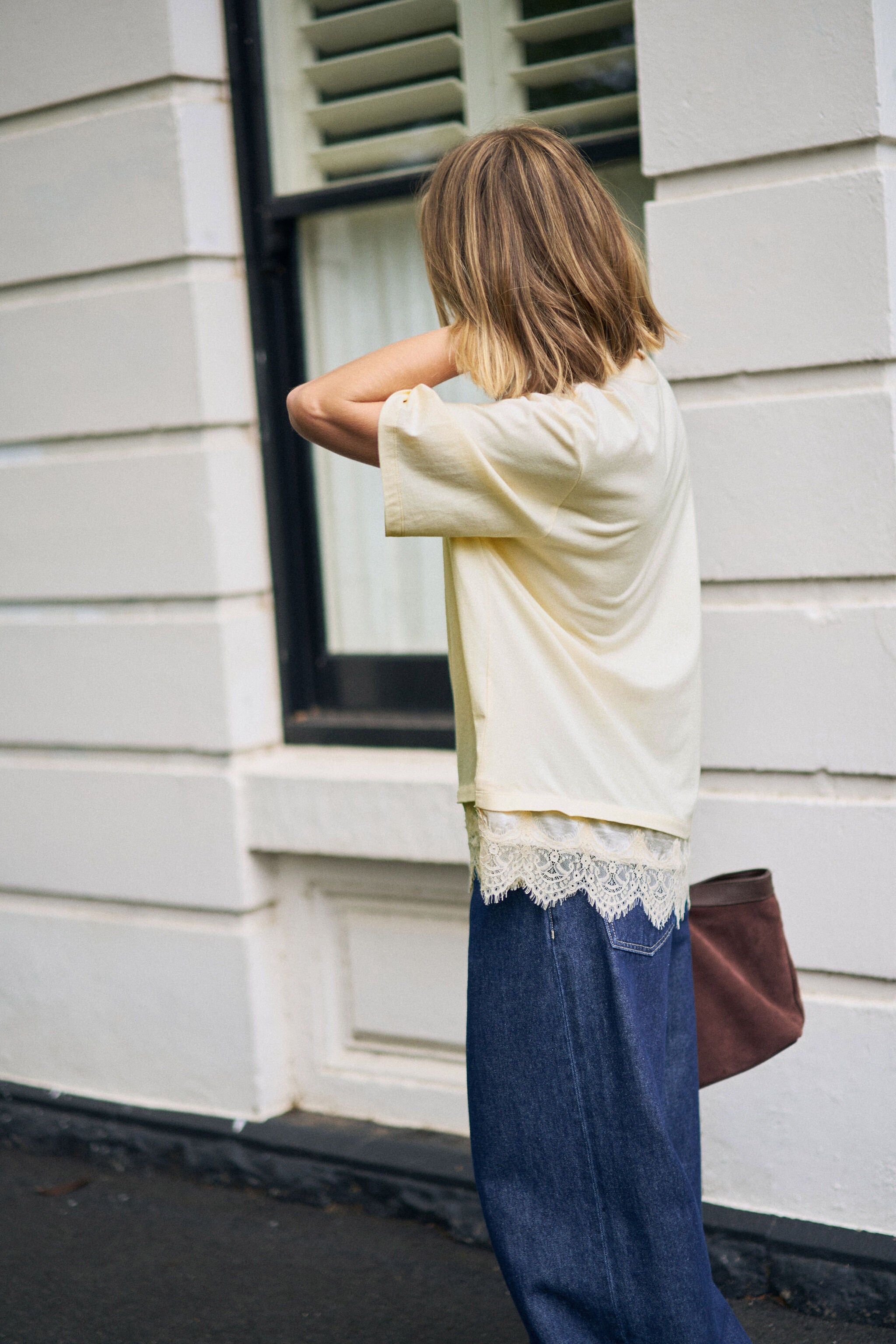 Side angle view of Lacey Tee showing relaxed fit and oversized silhouette
