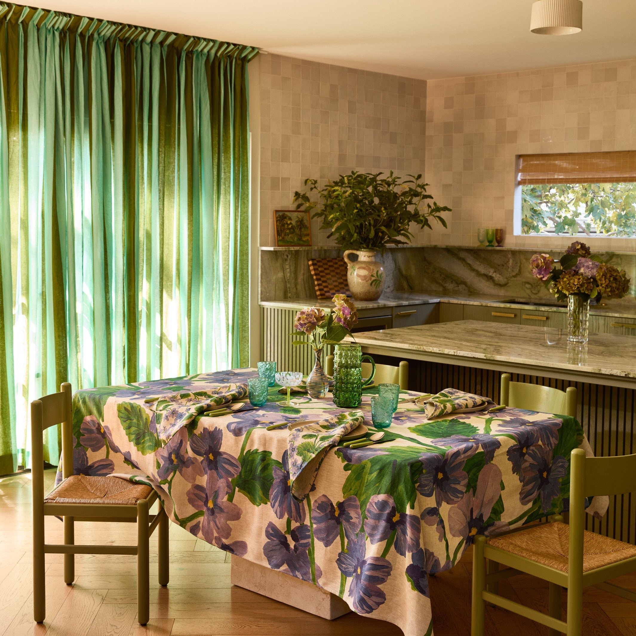 Lilas Blue Tablecloth with purple floral print covering dining table in modern kitchen setting