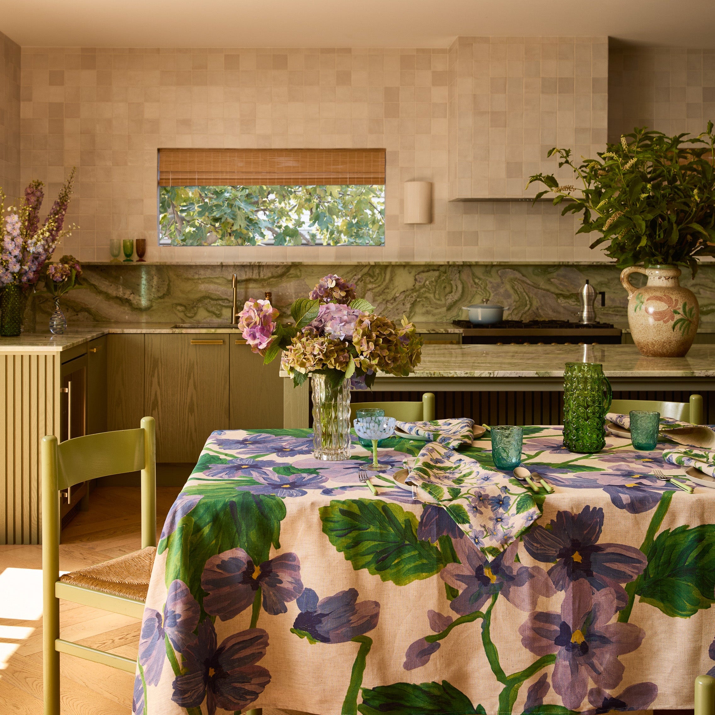 Lilas Blue Tablecloth draped over dining table showing full floral motif and natural fabric drape