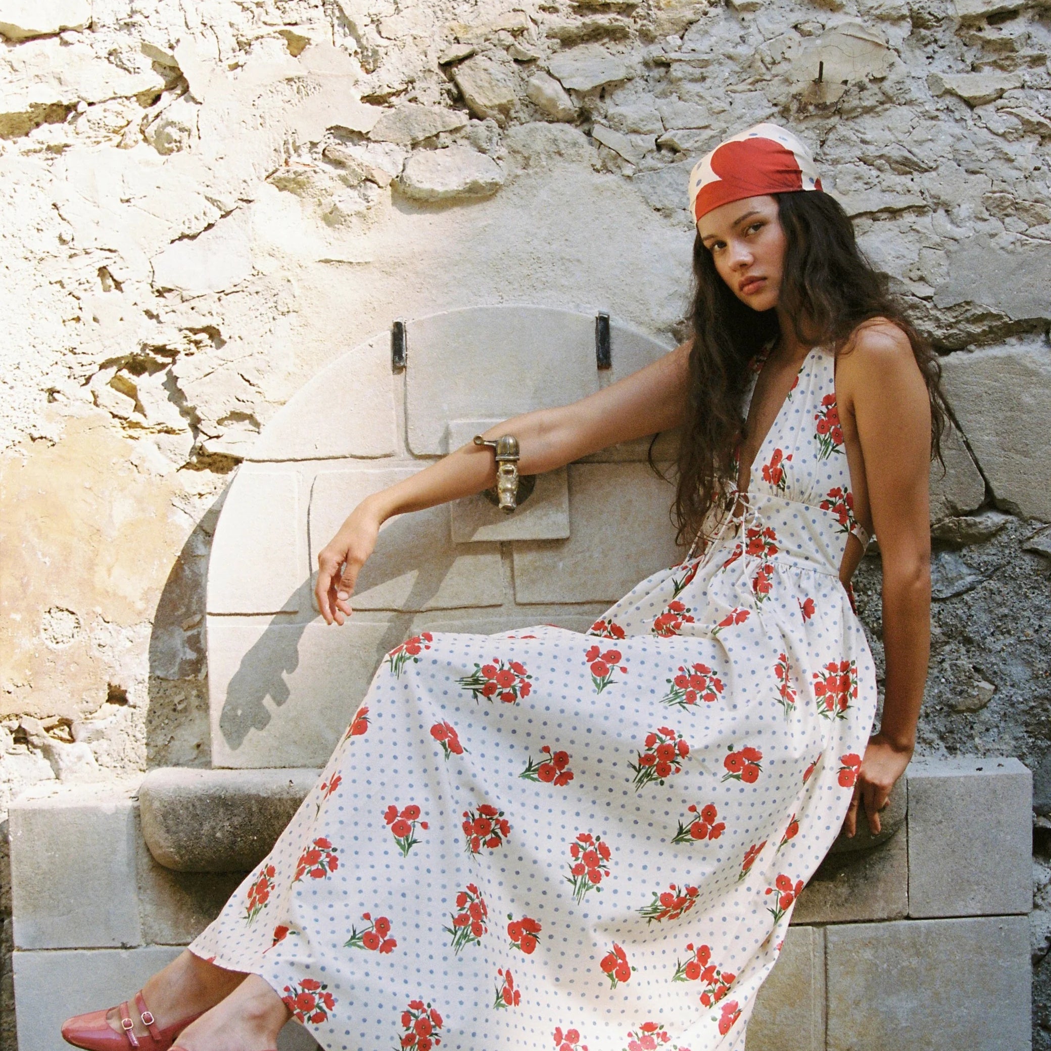 modelling sitting down wearing the Lily Maxi Dress Poppies by JUNI
