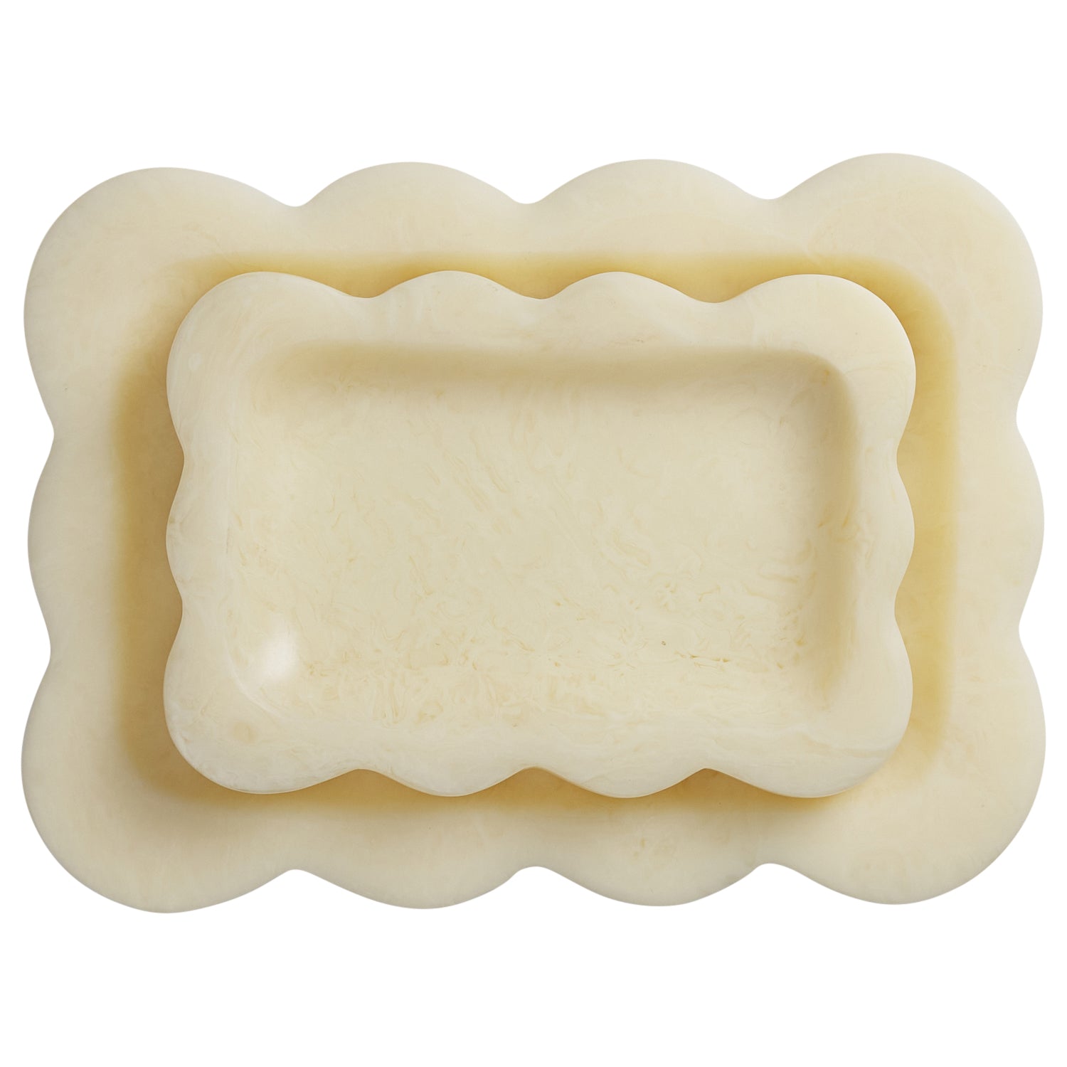 Pearl cream resin scalloped trays nested together, overhead view showing marbled texture detail