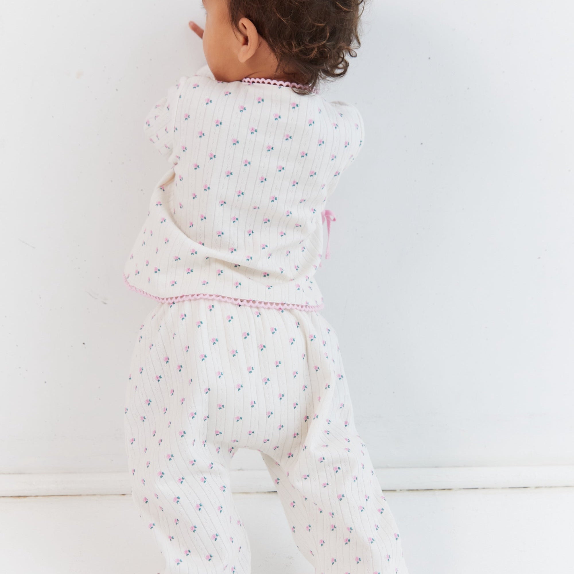 Back view of child wearing complete Lolly Set showing roses pattern and pink trim