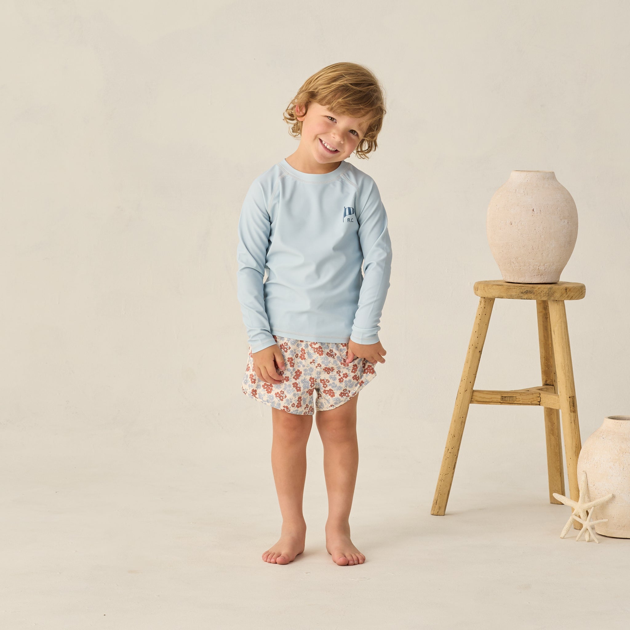 Front view of boy wearing Long Sleeve Rashguard Light Blue | Rylee + Cru