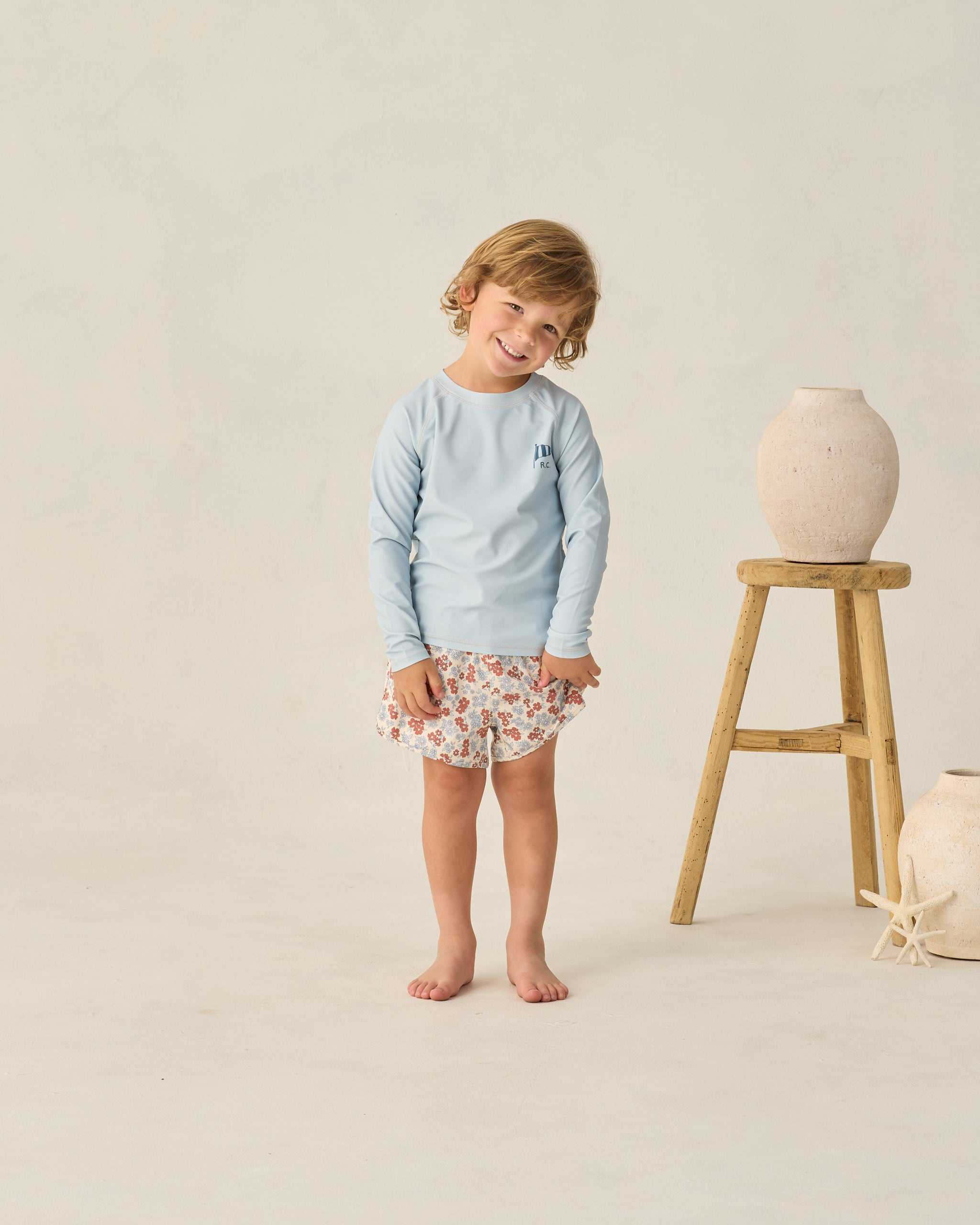 Front view of boy wearing Long Sleeve Rashguard Light Blue | Rylee + Cru