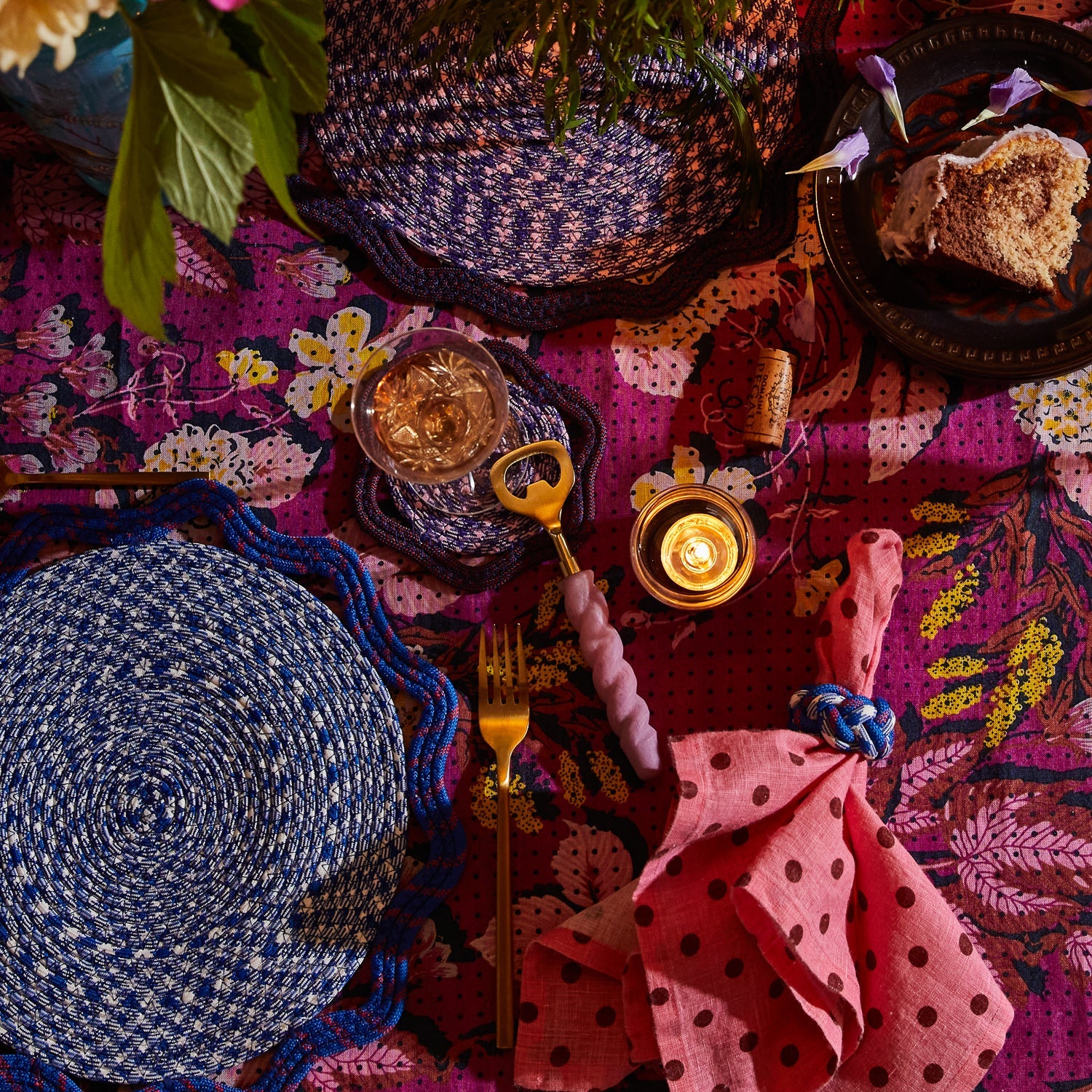 Orchid twisted-handle bottle opener laid in a vibrant boho tablescape with woven placemats and napkins