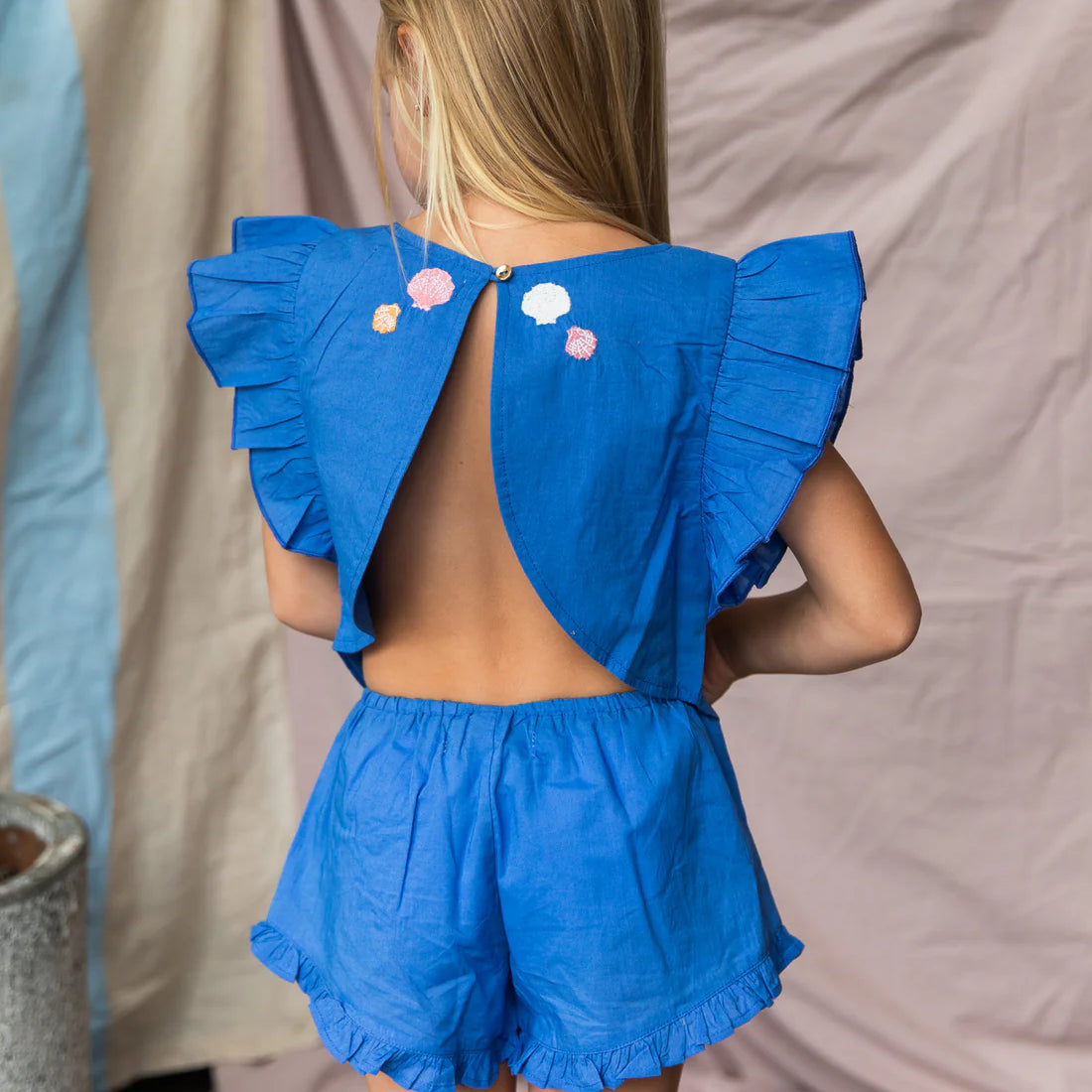 Girl wearing blue 100%cotton top with open back and coral embroidery - Lucia Top Yves Klien by Pearson and Pearson