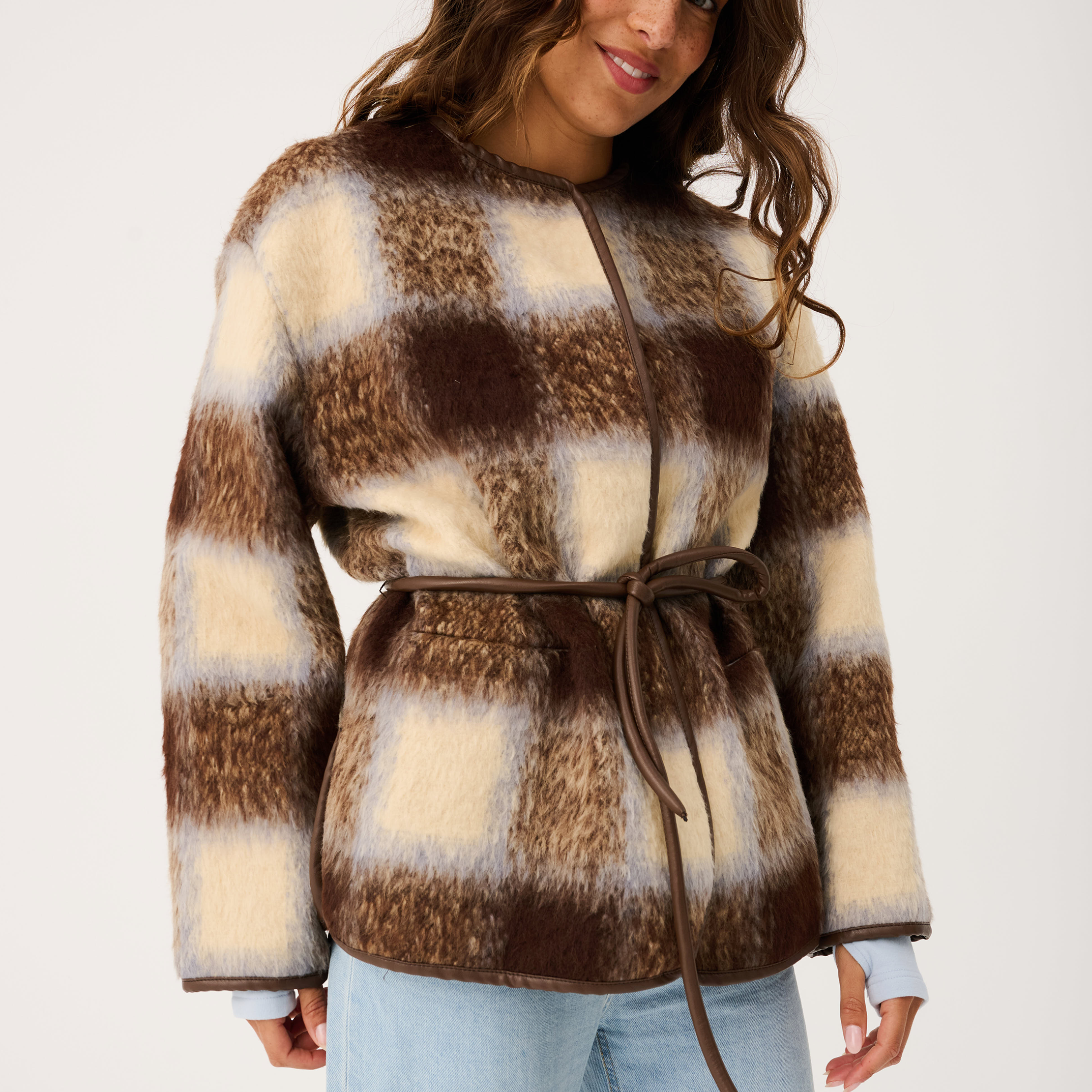 Close-up front view of Luka Jacket displaying brown cream check faux fur with tie waist detail
