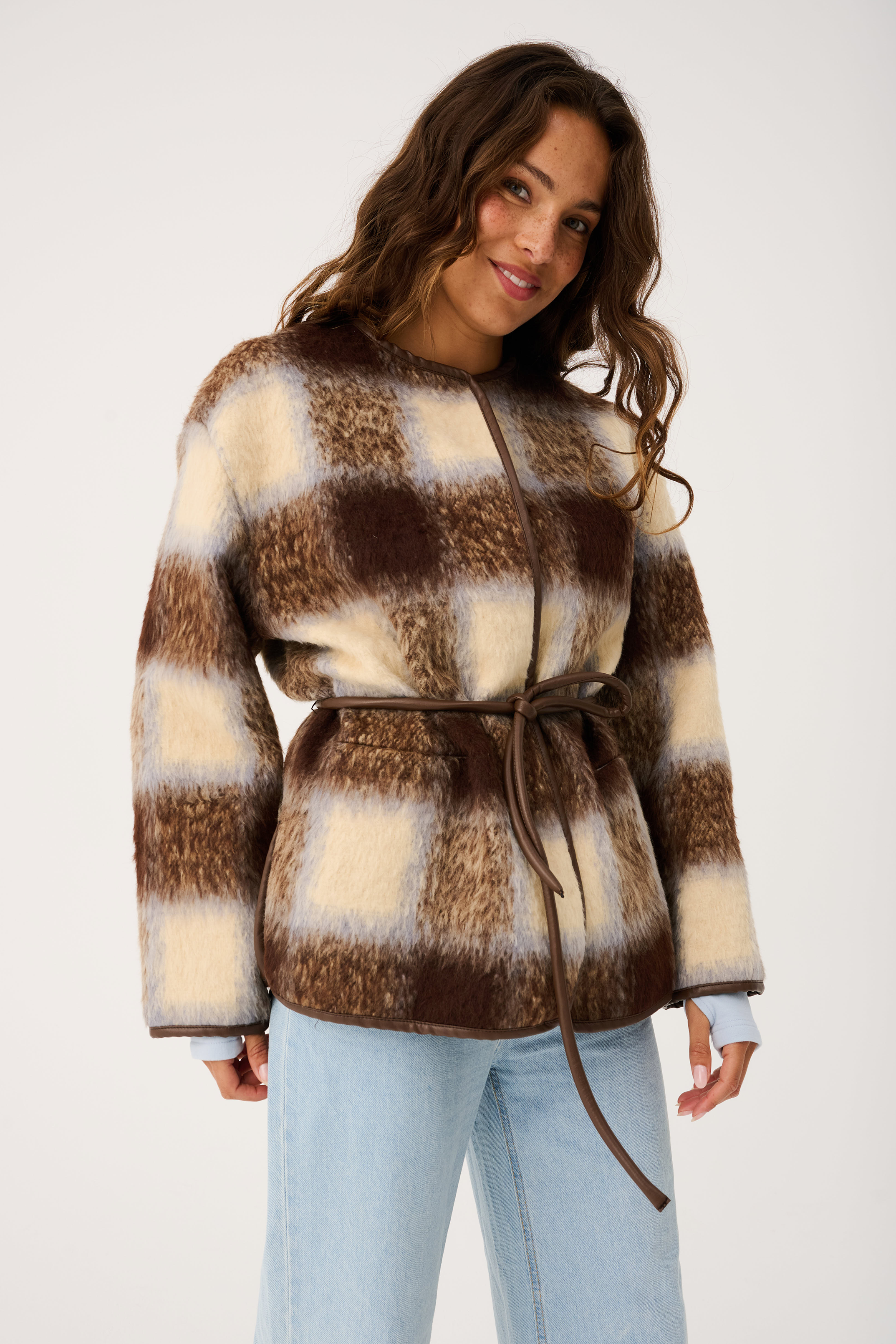 Close-up front view of Luka Jacket displaying brown cream check faux fur with tie waist detail