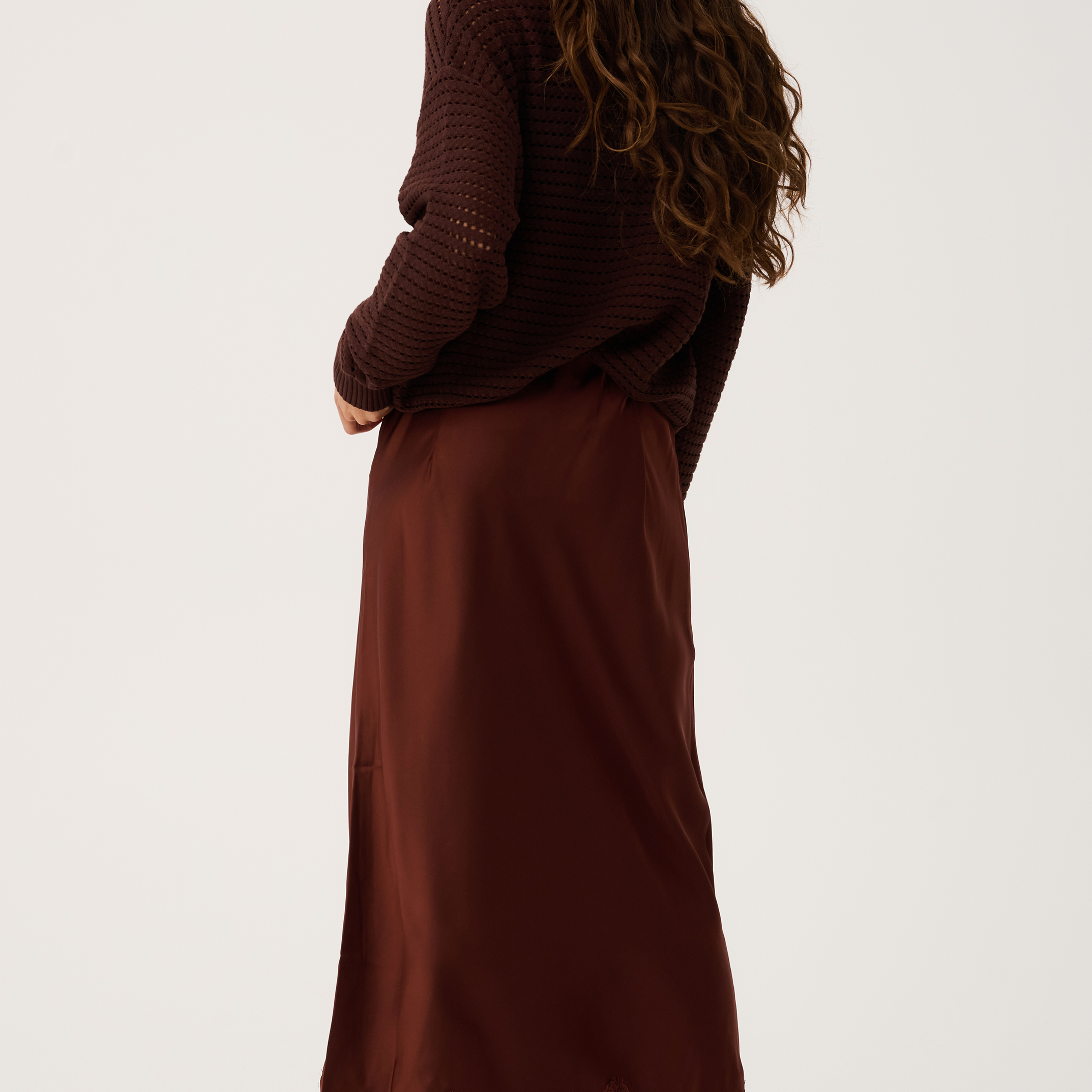 Back view of Luna Skirt in truffle brown showing midi length silhouette and delicate lace hem detail