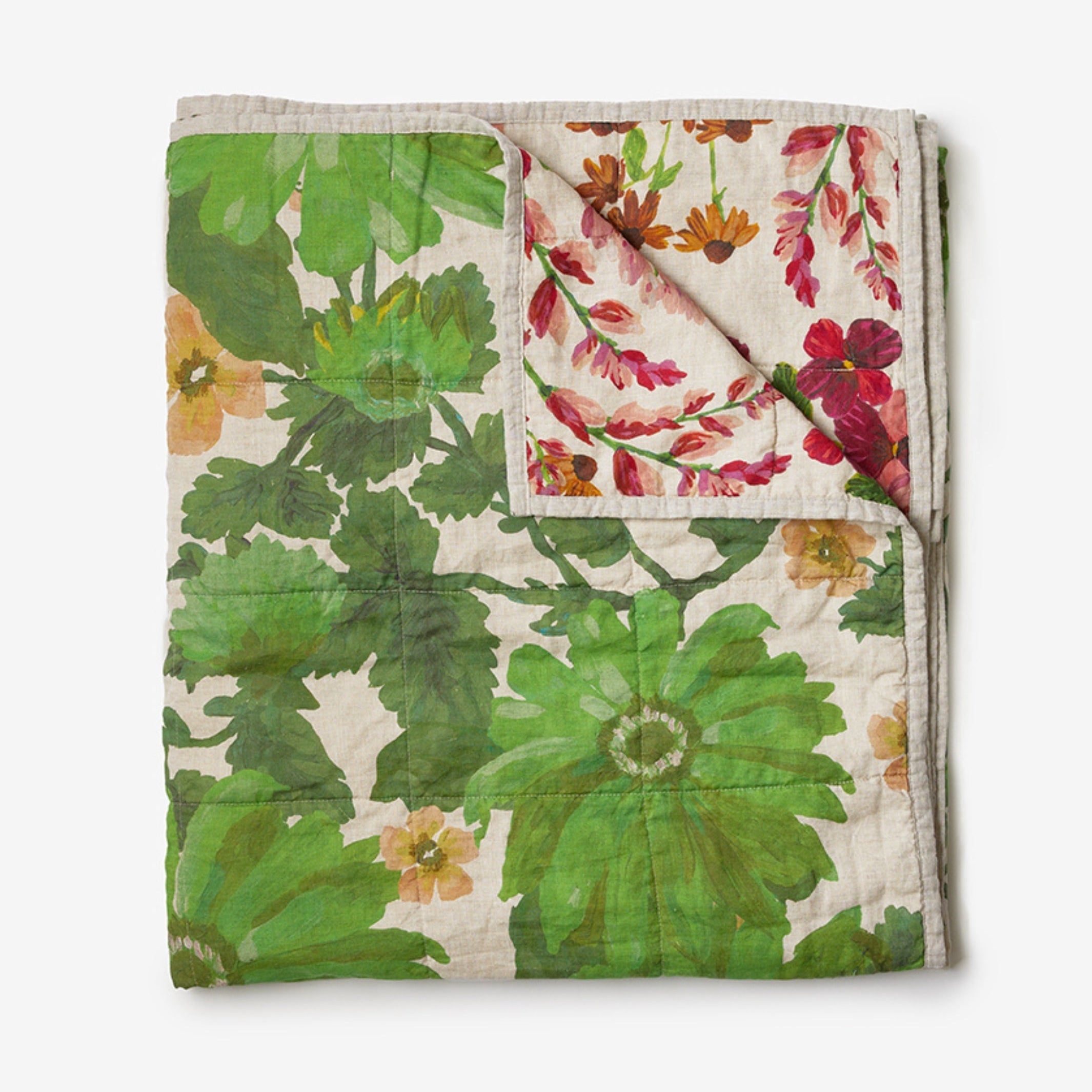 Flat lay of Lupin Multi & Marigold Leaf linen quilted throw showing reversible botanical design