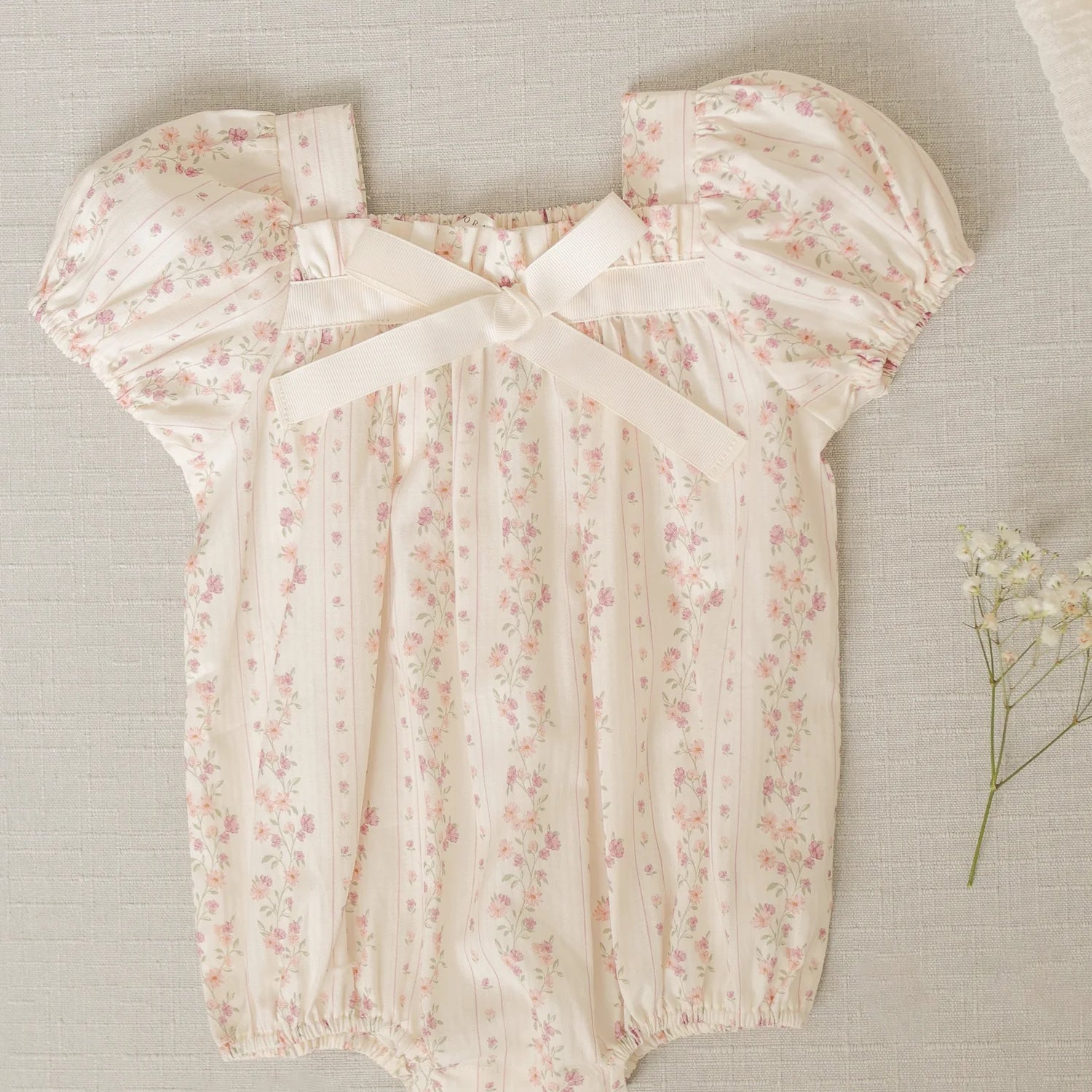 Flat lay of Lyla Romper Floral Stripe by Noralee