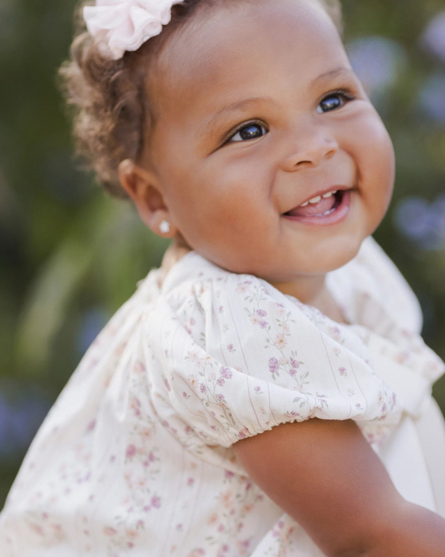 baby girl wearing Lyla Romper Floral Stripe by Noralee