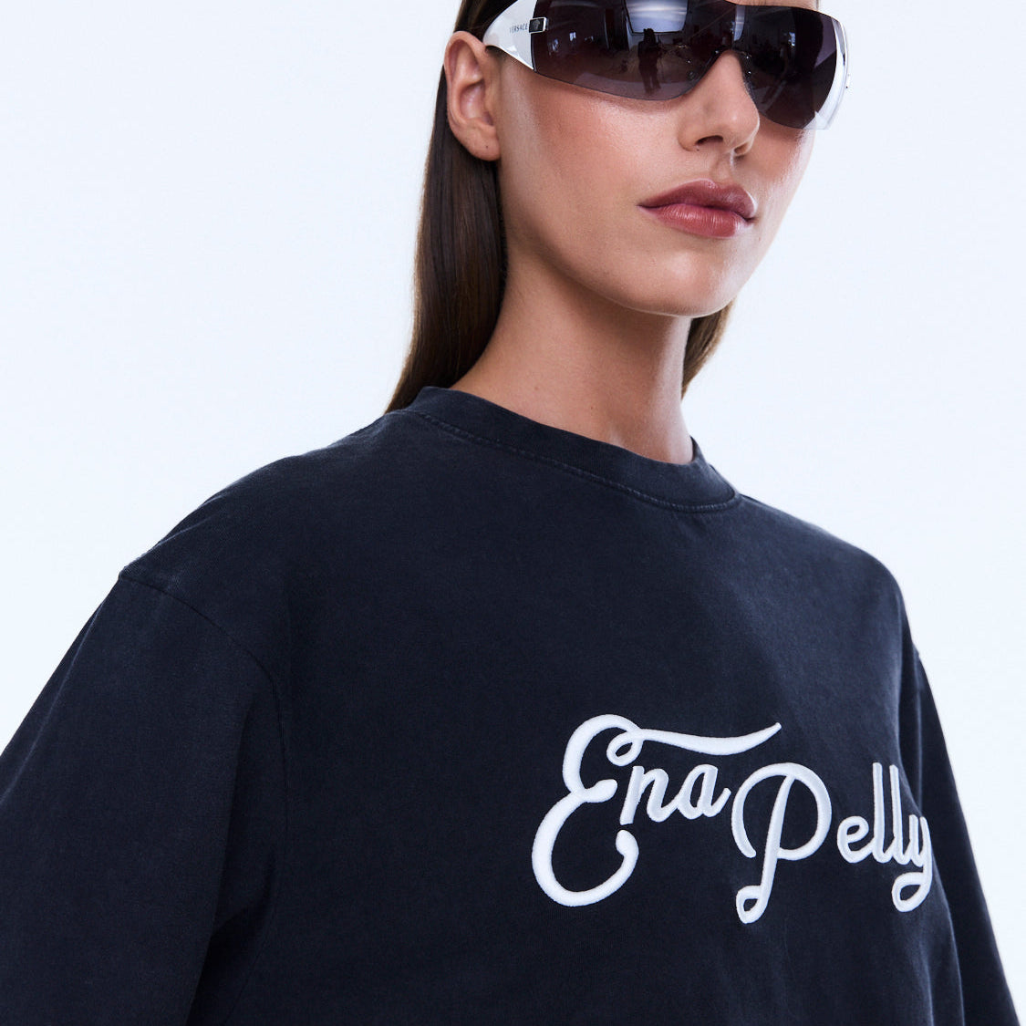 Close-up detail of Mock Layer Long Sleeve Tee showing white script logo on vintage black fabric