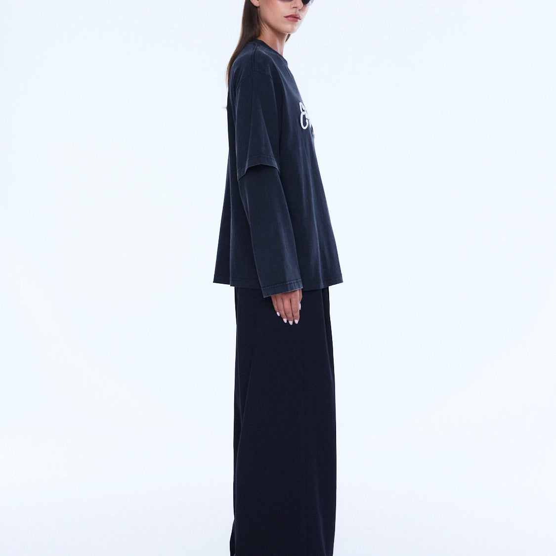 Side profile view of Mock Layer Long Sleeve Tee displaying layered sleeve detail and oversized fit