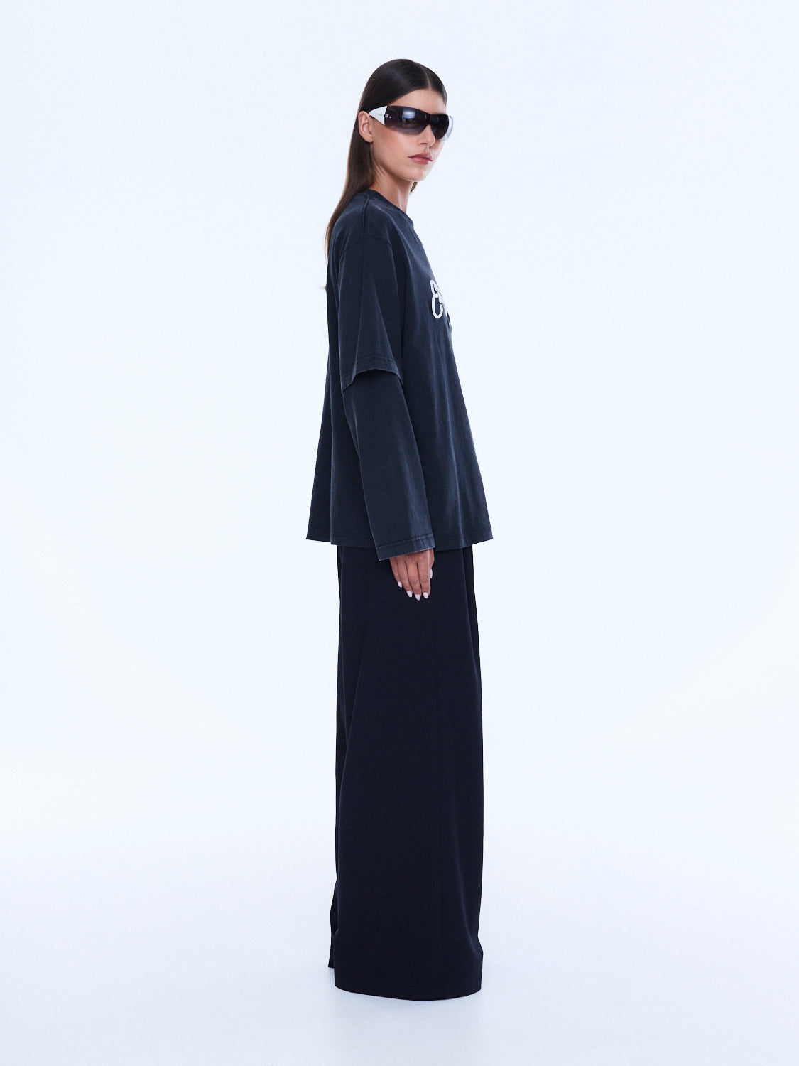Side profile view of Mock Layer Long Sleeve Tee displaying layered sleeve detail and oversized fit