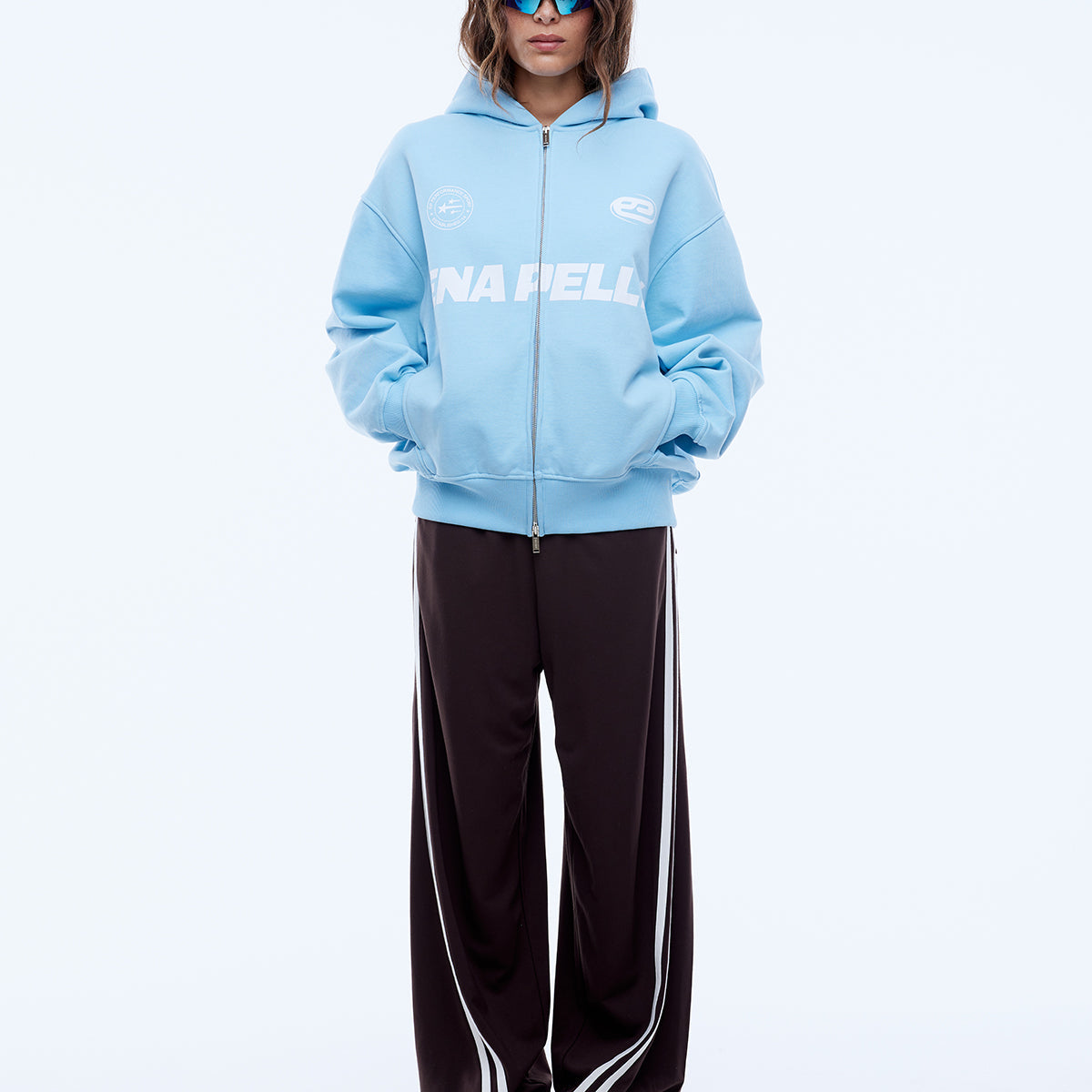 Full body front view of cloud blue multi logo hoodie with zip closure and oversized fit