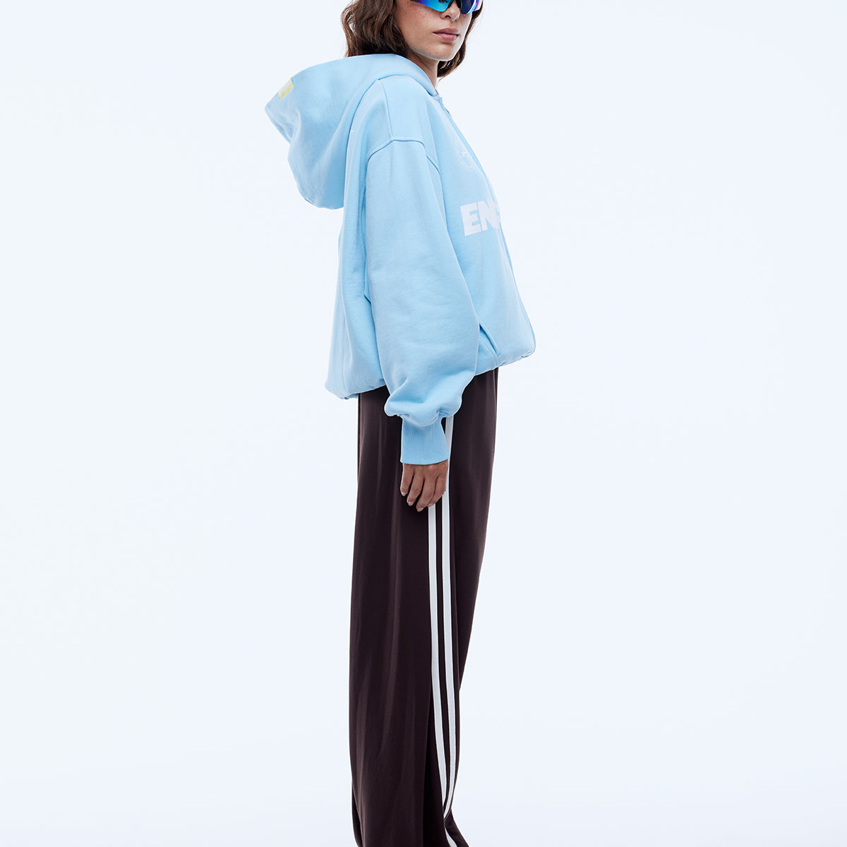 Side profile view of cloud blue zip hoodie showing relaxed silhouette and hood shape