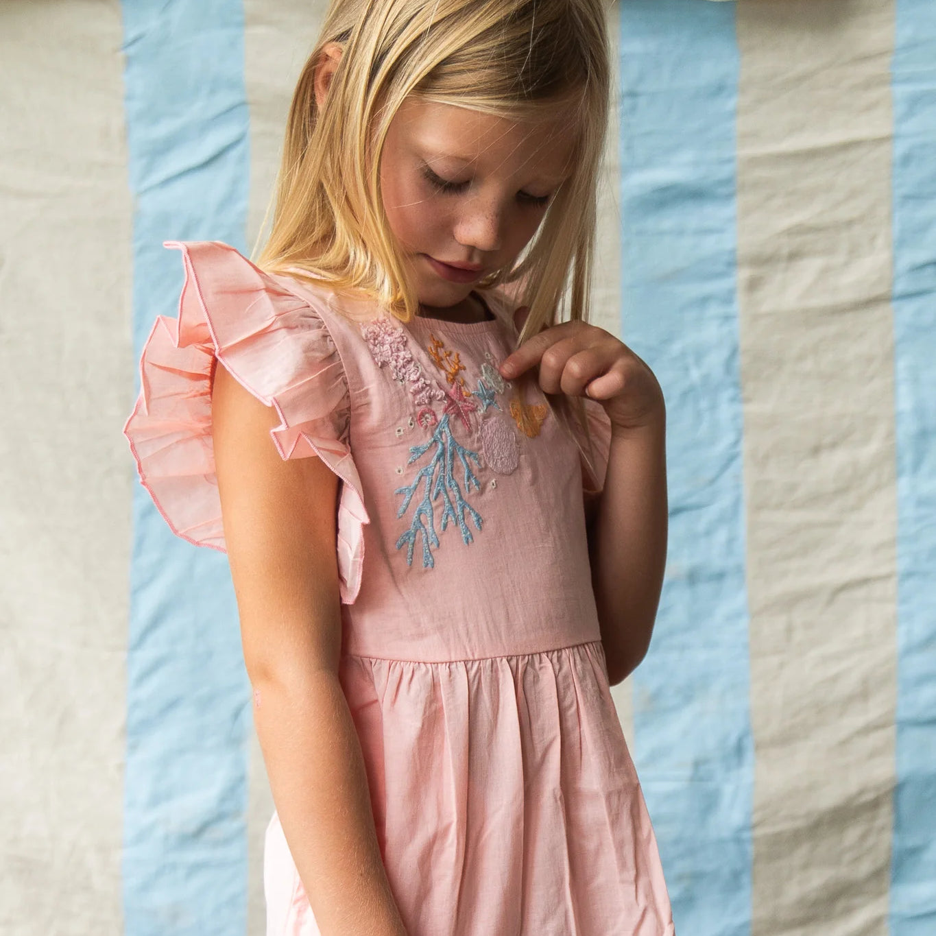 Girl wearing pink dress with coral embroidery - Madelyn Dress – Pink Coral by Pearson & Pearson