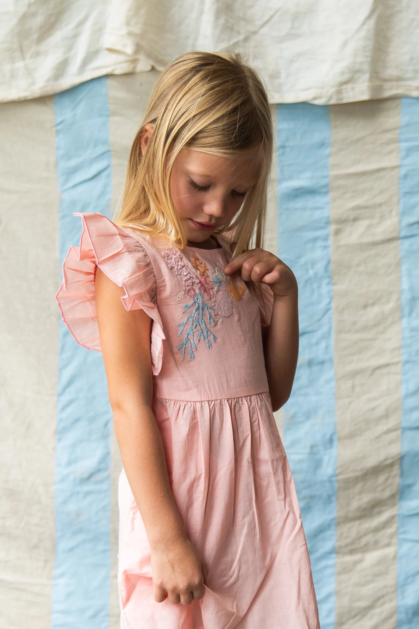 Girl wearing pink dress with coral embroidery - Madelyn Dress – Pink Coral by Pearson & Pearson