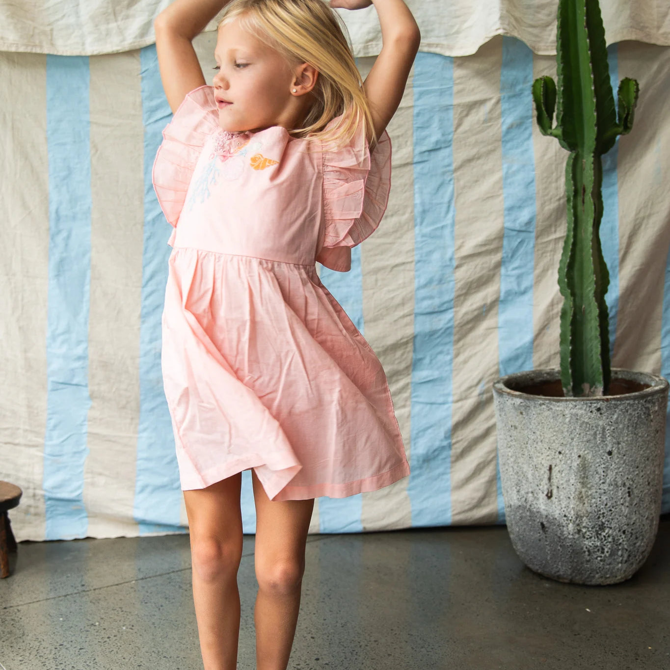 girl wearing pink madelyn dress by Pearson and Pearson