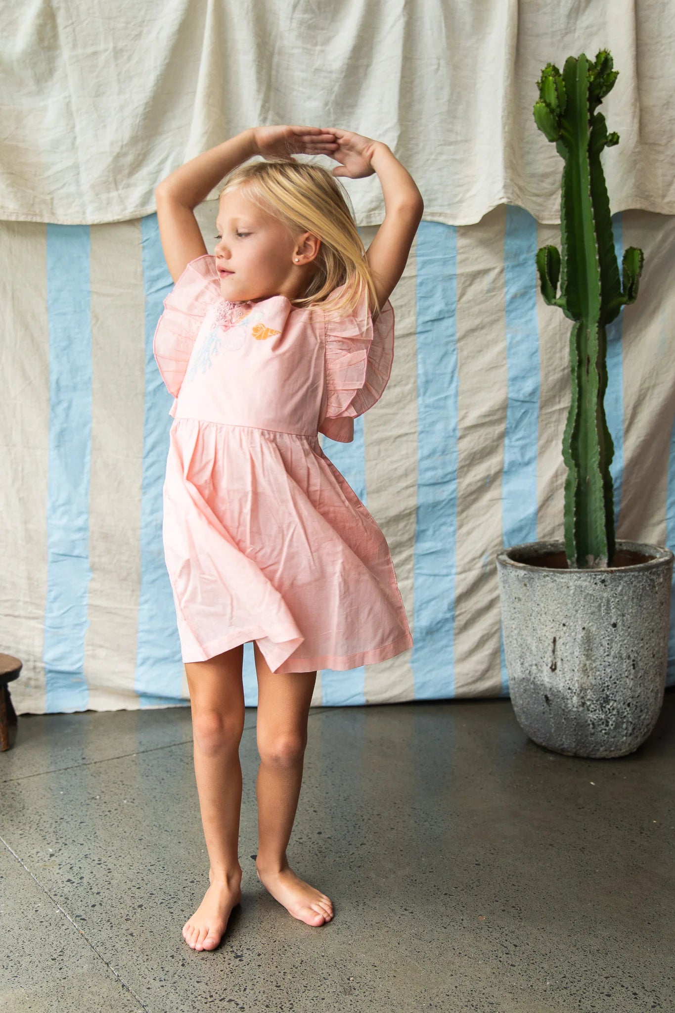 girl wearing pink madelyn dress by Pearson and Pearson