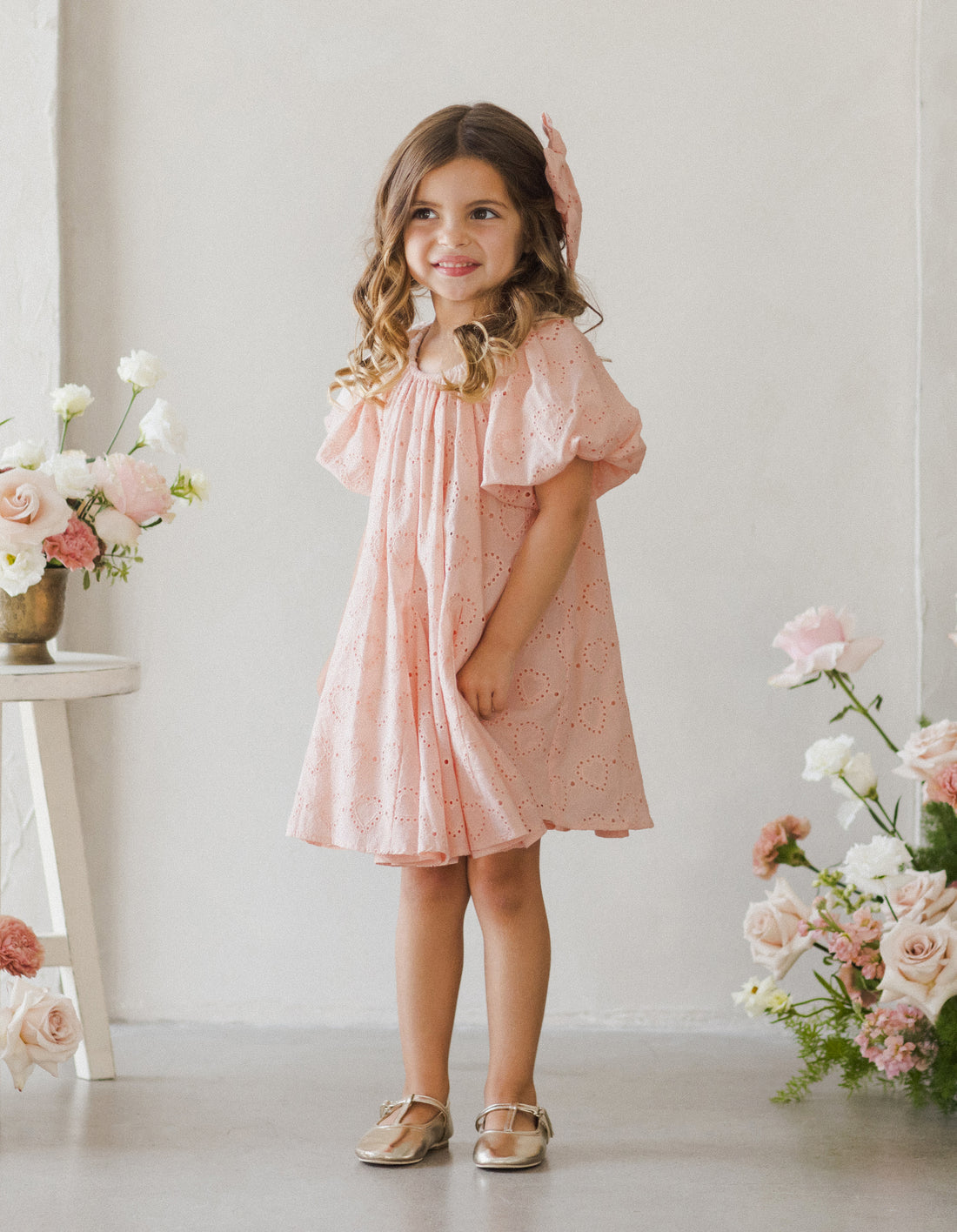 Pinks flowergirl dress with heart details and puff sleeves by Noralee