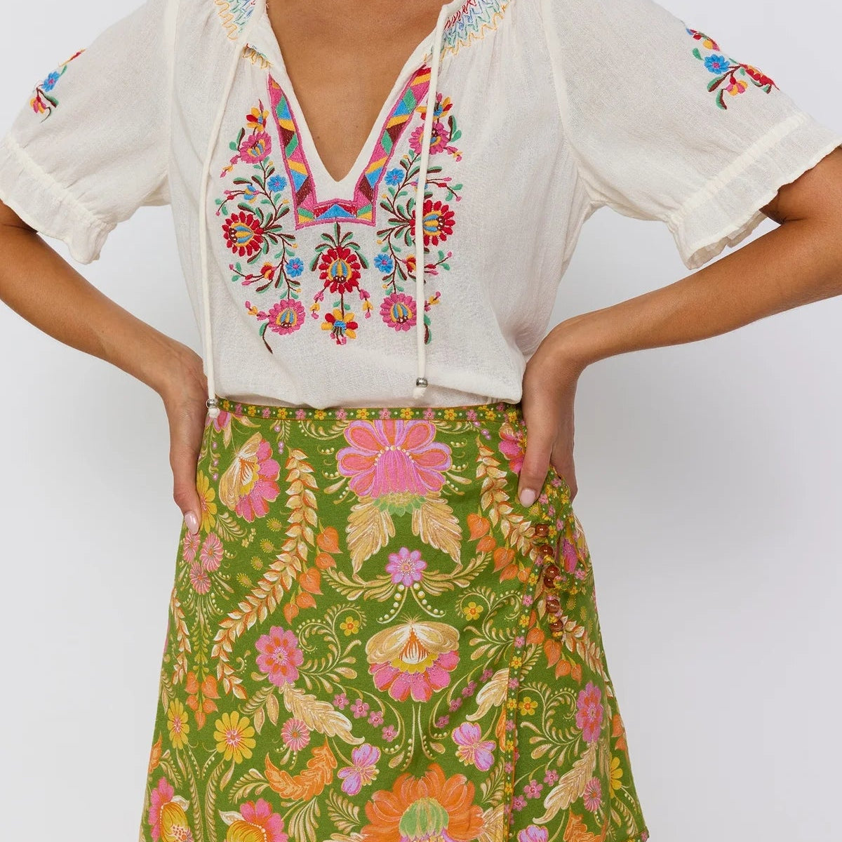 Guava mini skirt A-line wrap silhouette with lace-up hip detail Nine Lives Bazaar